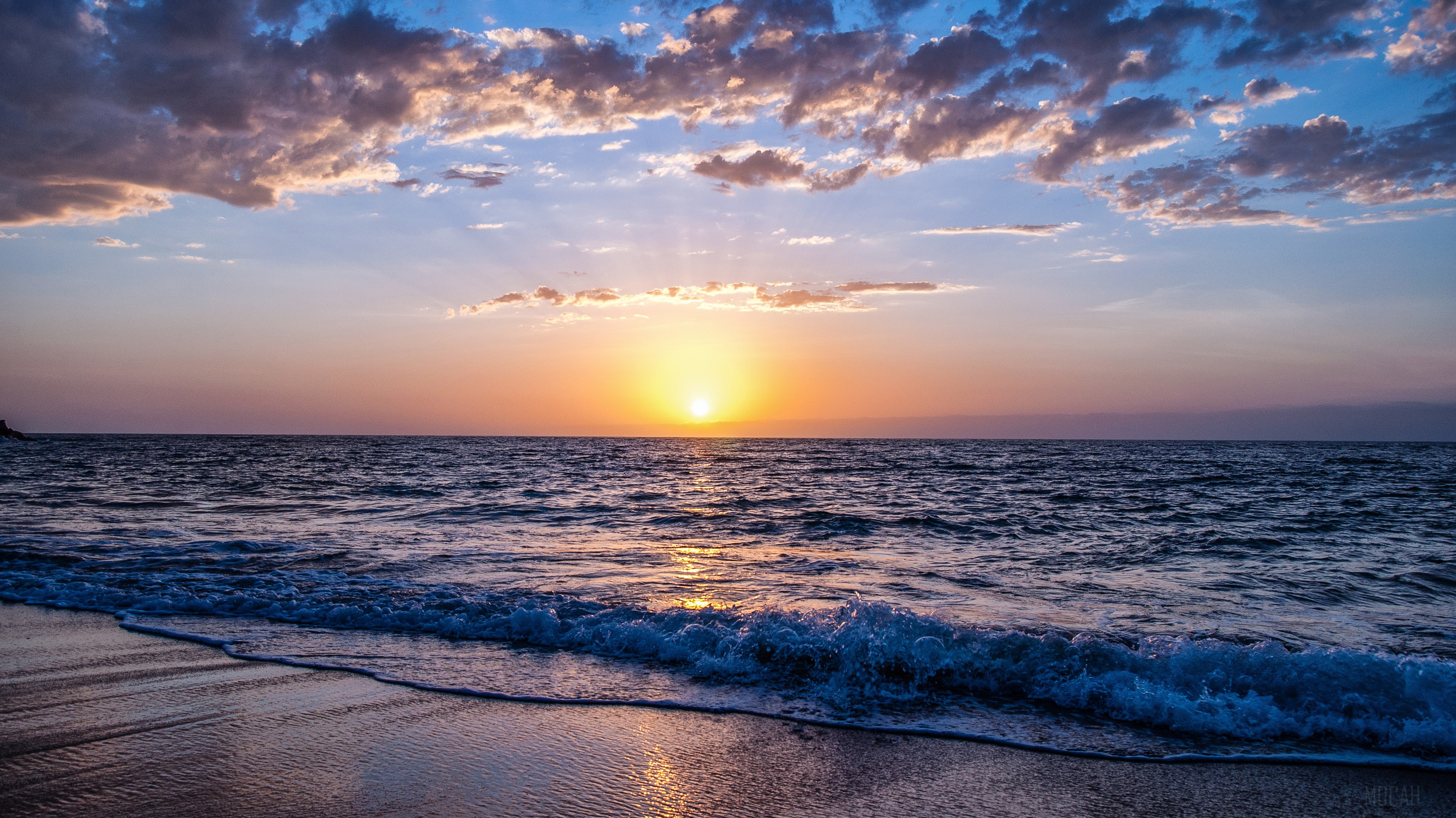 Sunset over the ocean with clouds and waves HD Wallpaper