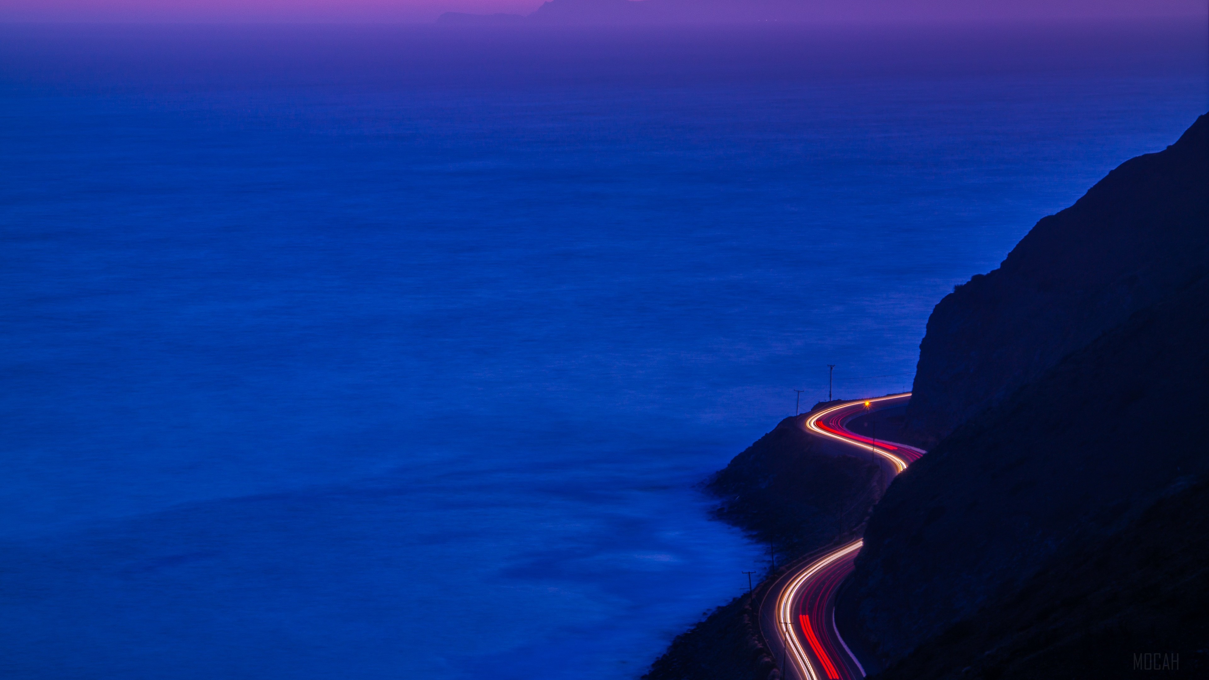 Light Trails on Mountain Road by the Ocean at Dusk 4K HD Wallpaper