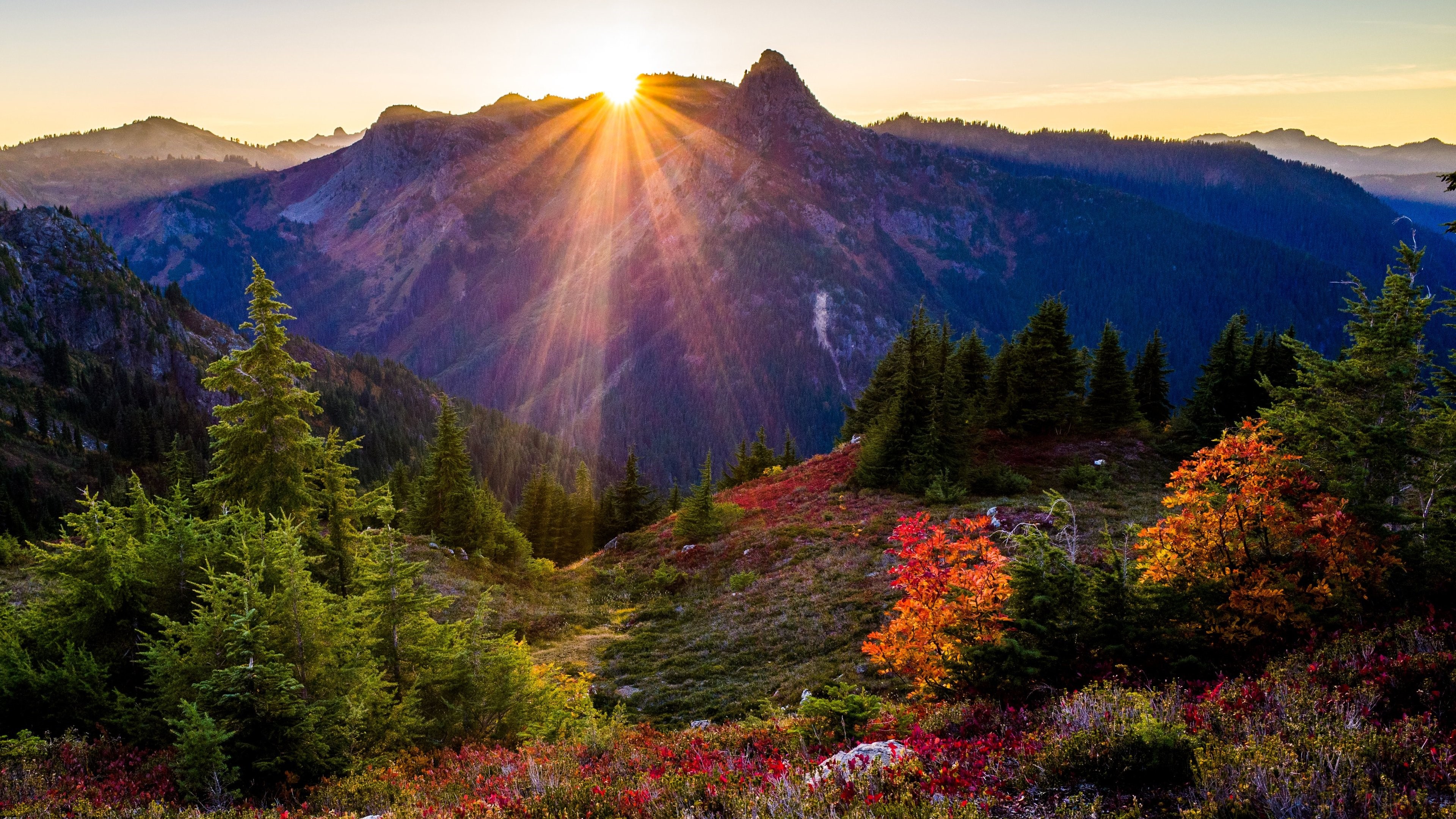 Sunrise over mountains with sun rays HD Wallpaper