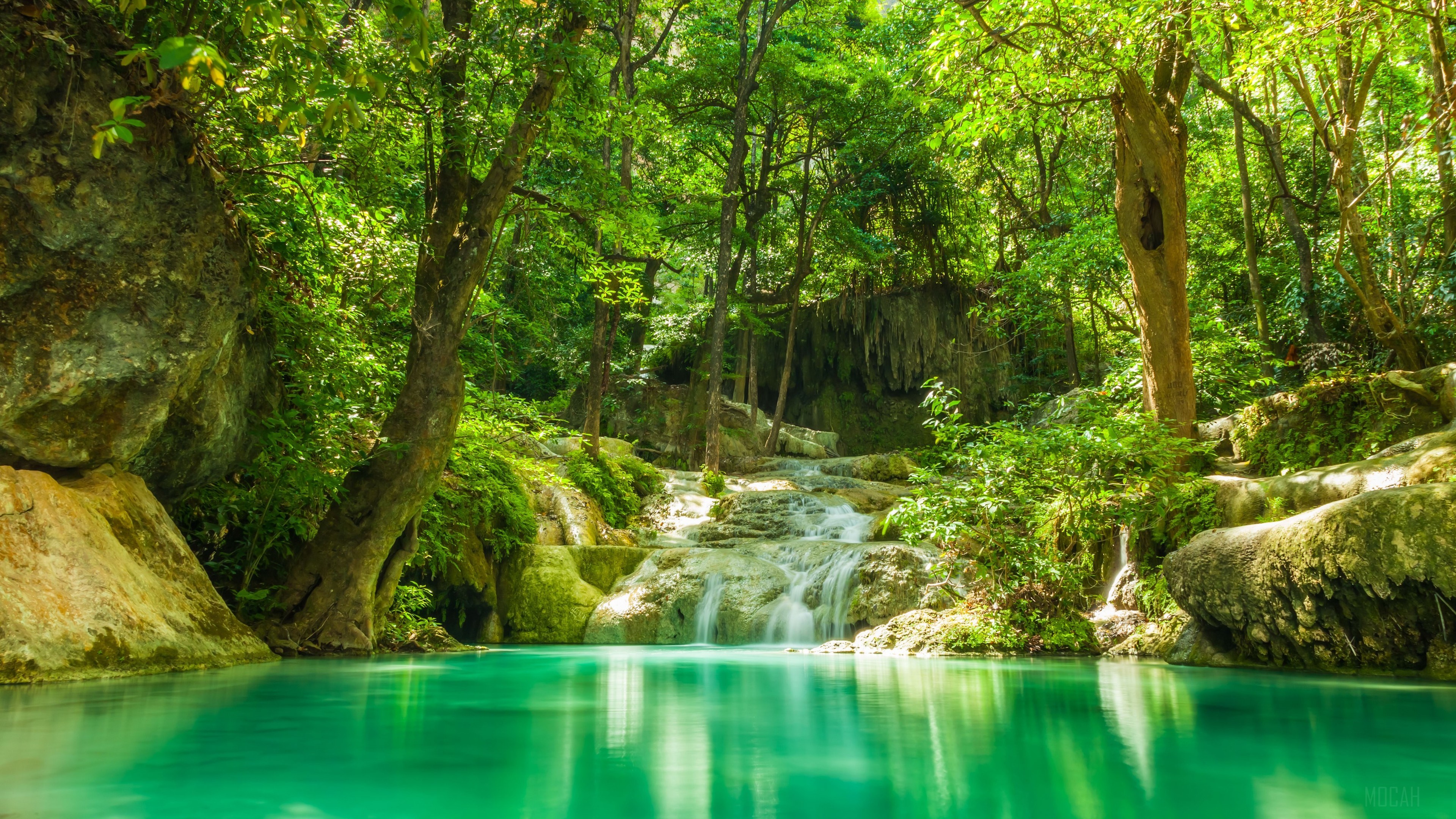 Turquoise lake and cascades in a lush forest 4K HD Wallpaper