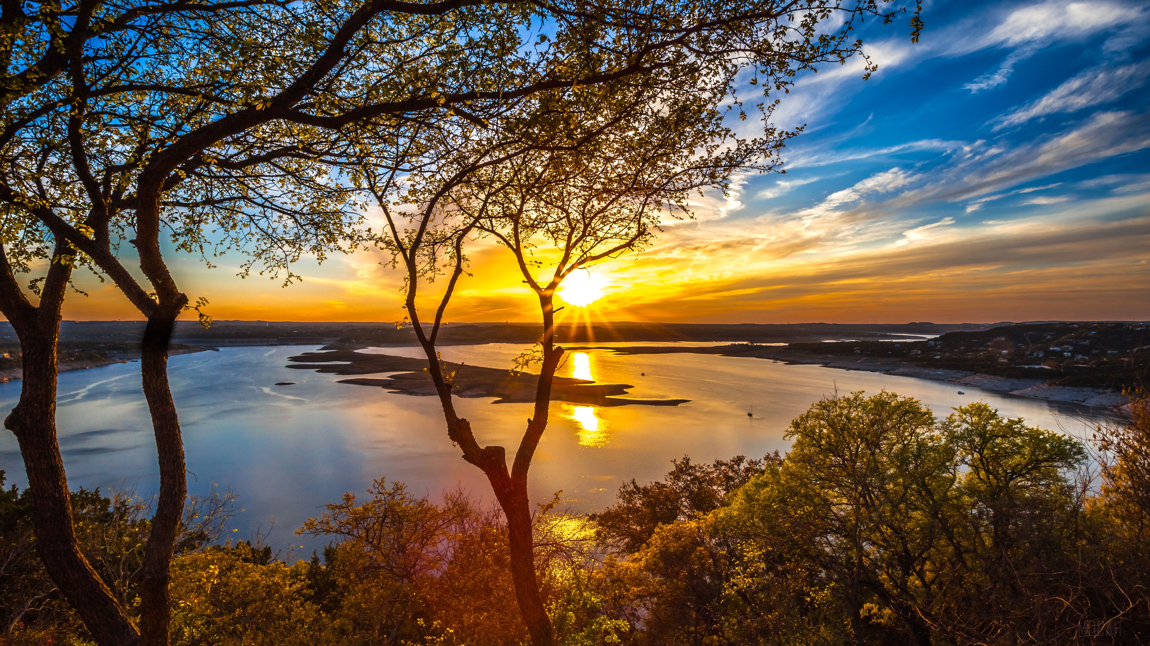 Sunset over Lake Travis with trees in foreground HD Wallpaper