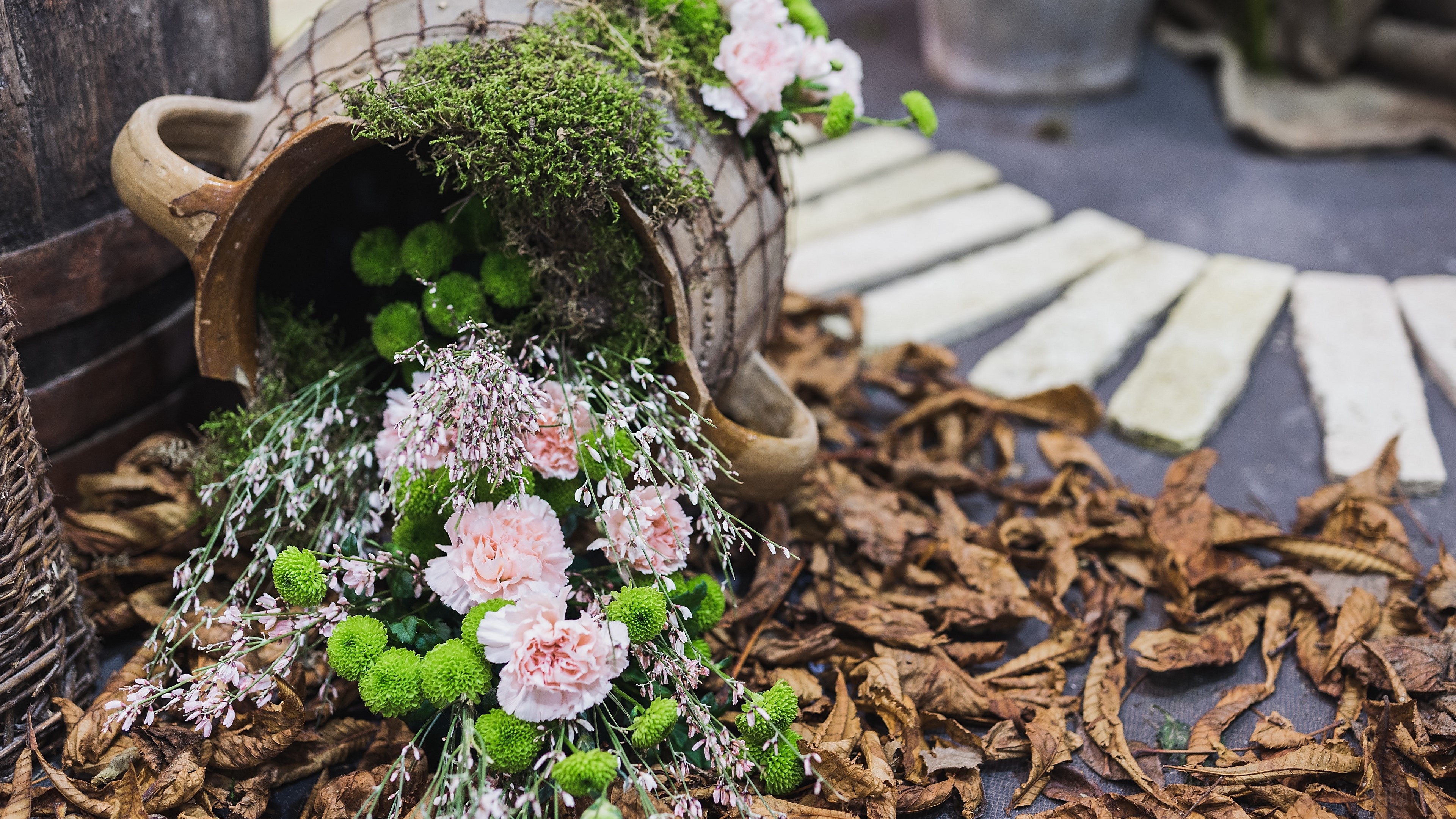 Flower arrangement in a jug with dried leaves HD Wallpaper
