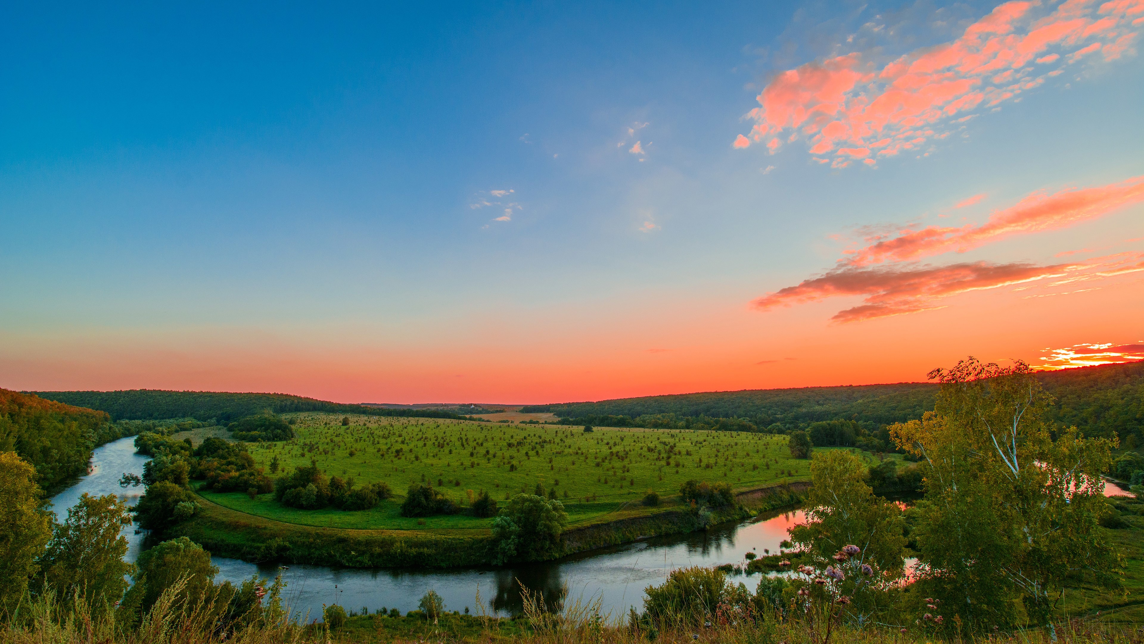 Red Sunset Over Hilly River Banks 4K HD Wallpaper