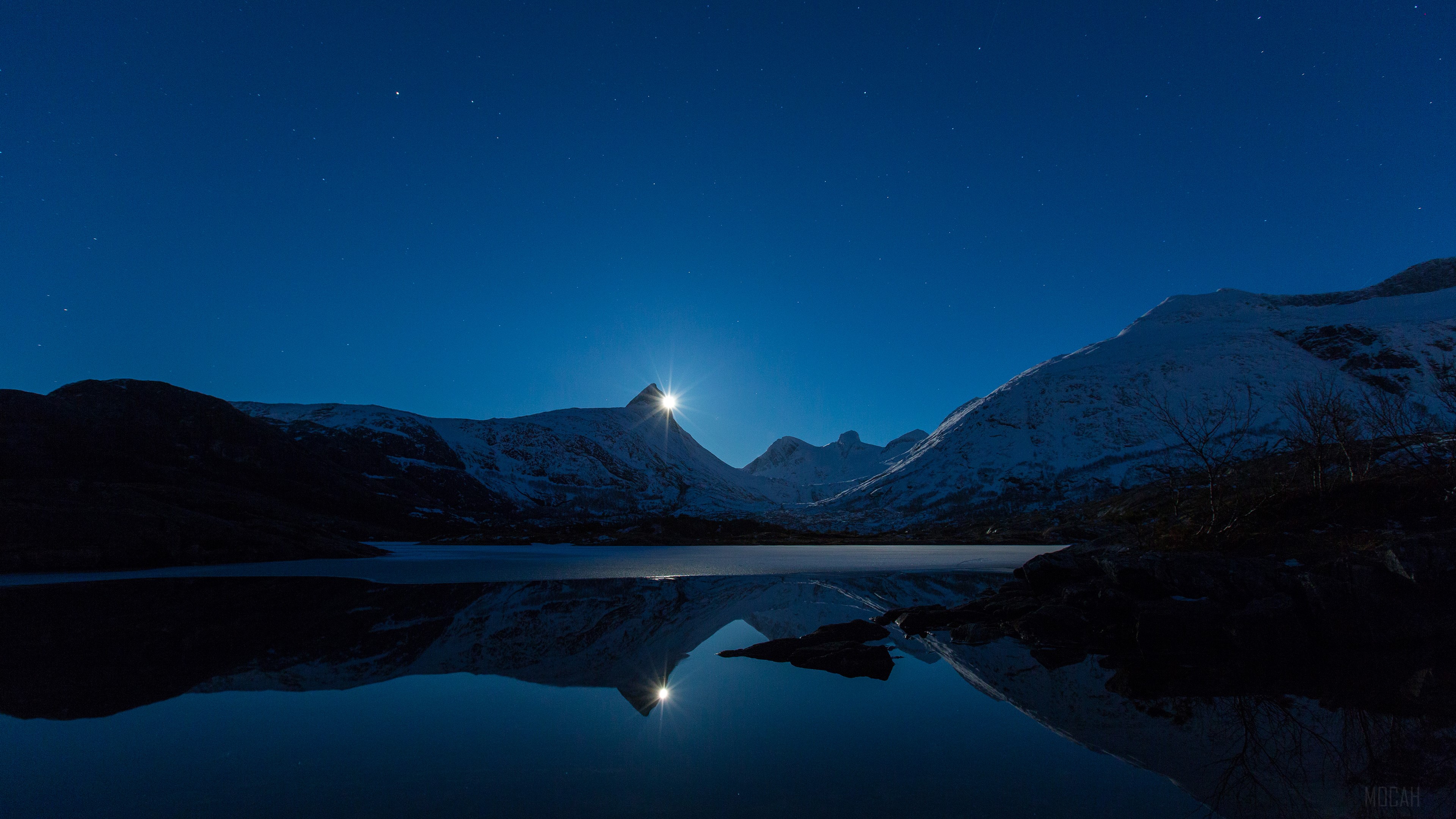 Moon behind snow-capped mountains over a lake HD Wallpaper