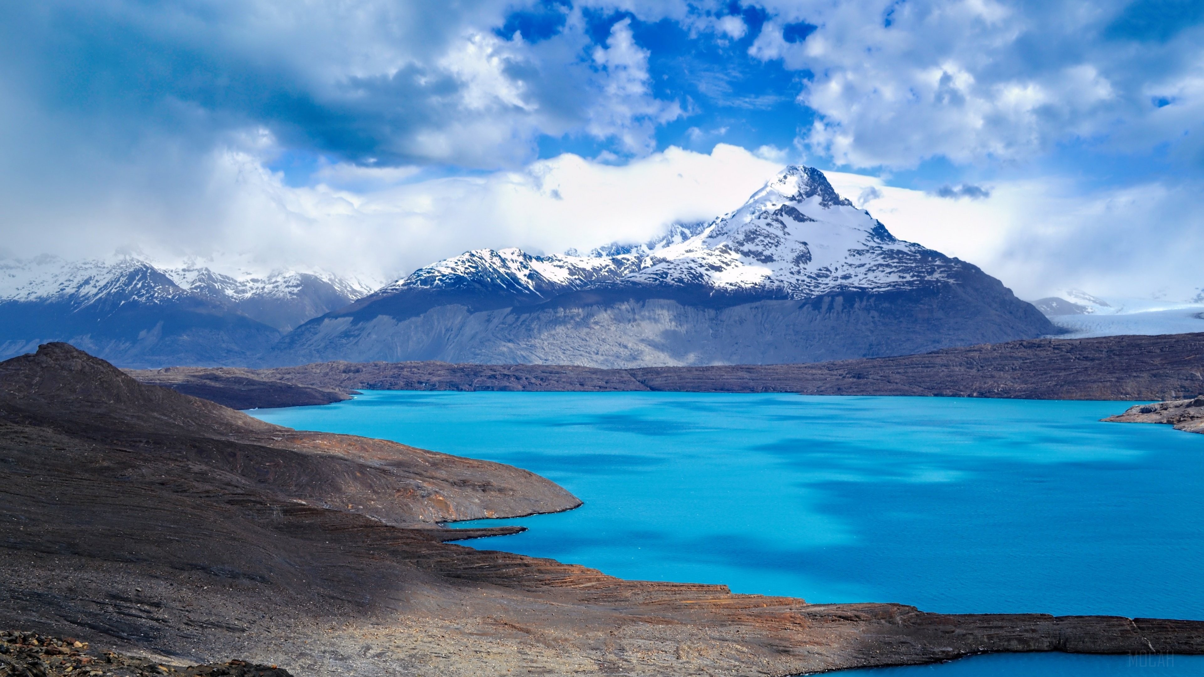 Mountains and Turquoise Lake under Cloudy Sky 4K HD Wallpaper
