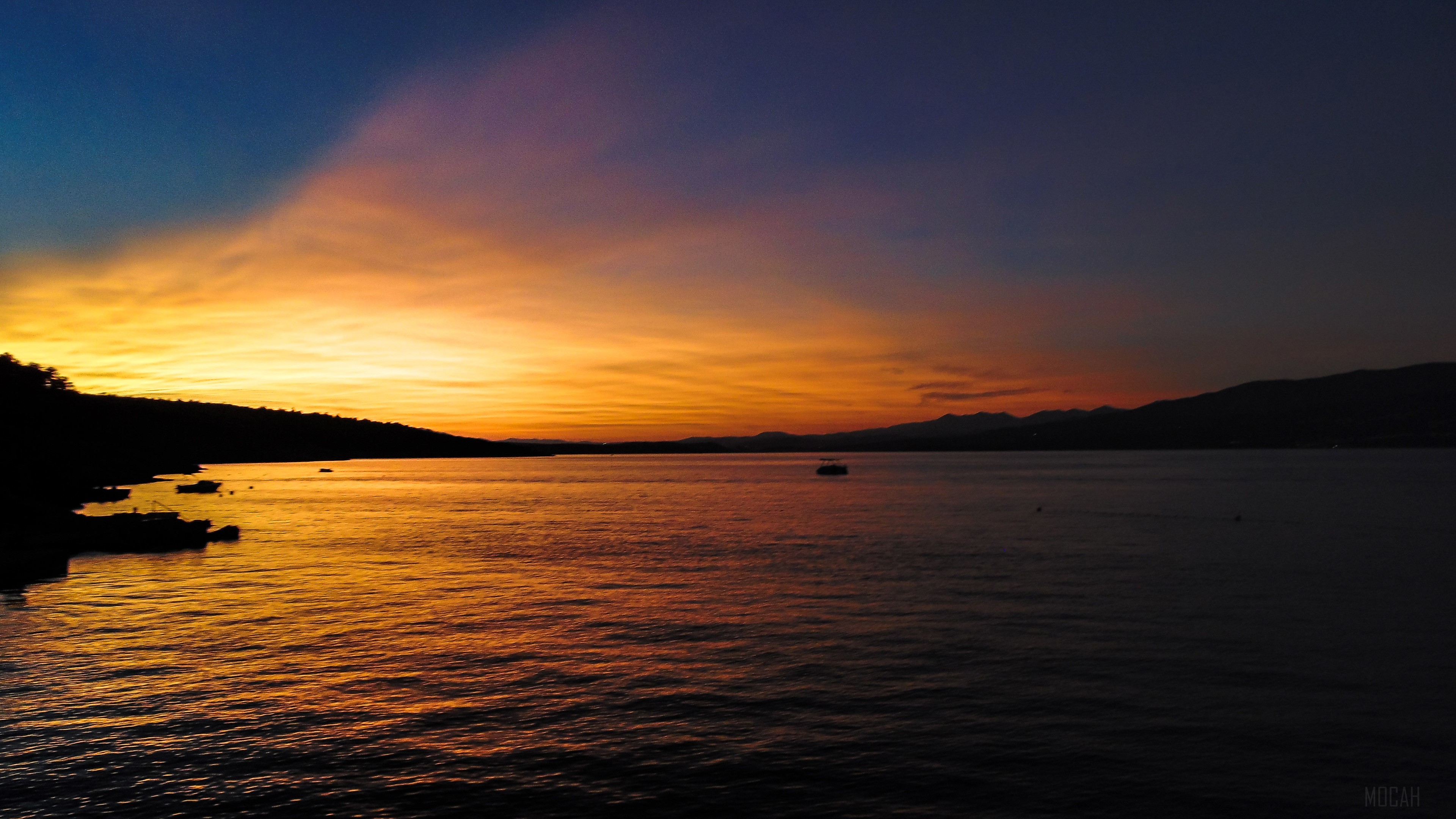 Sunset over the sea with mountains HD Wallpaper