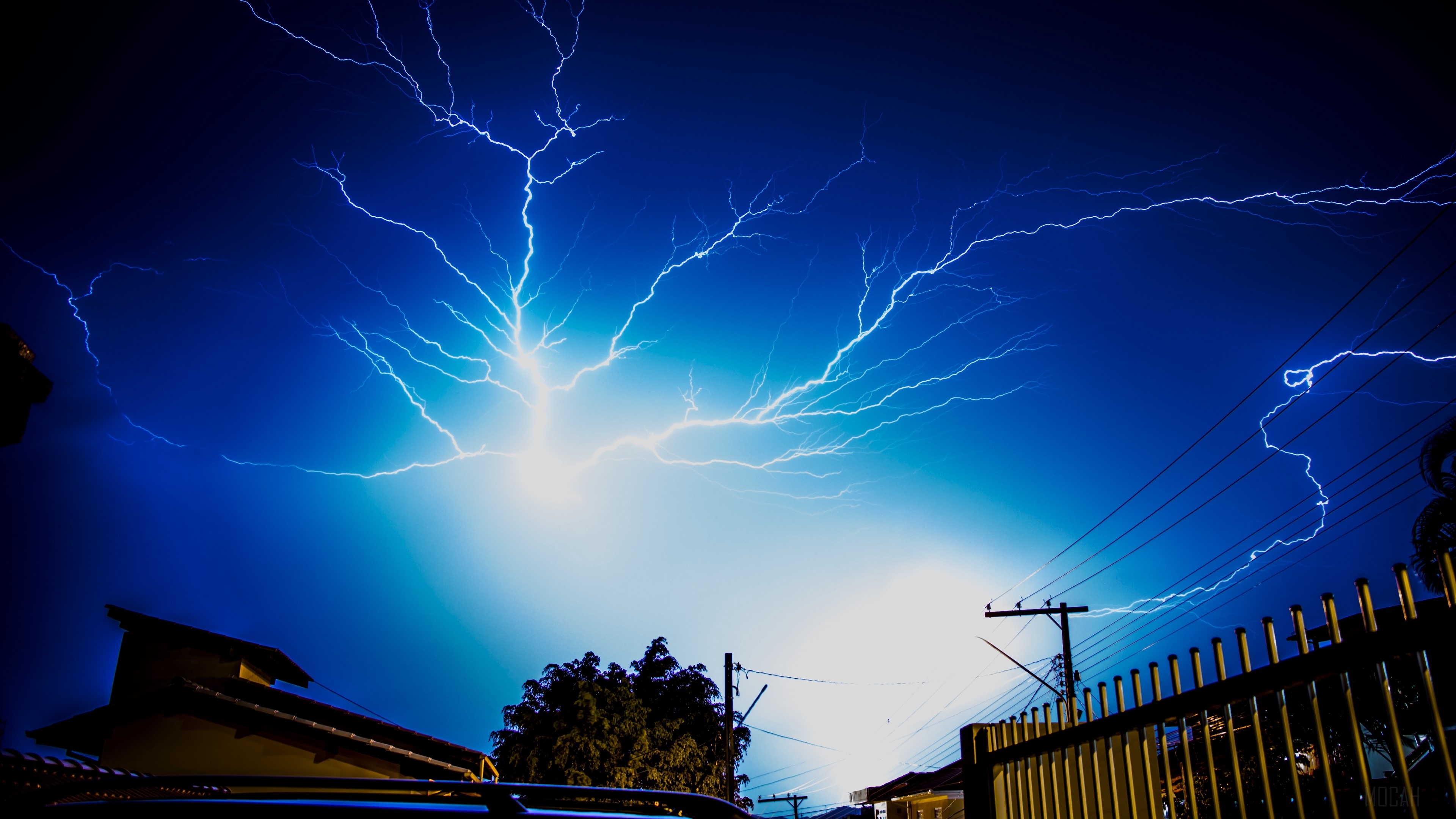 Lightning strikes in a dark blue sky at night HD Wallpaper