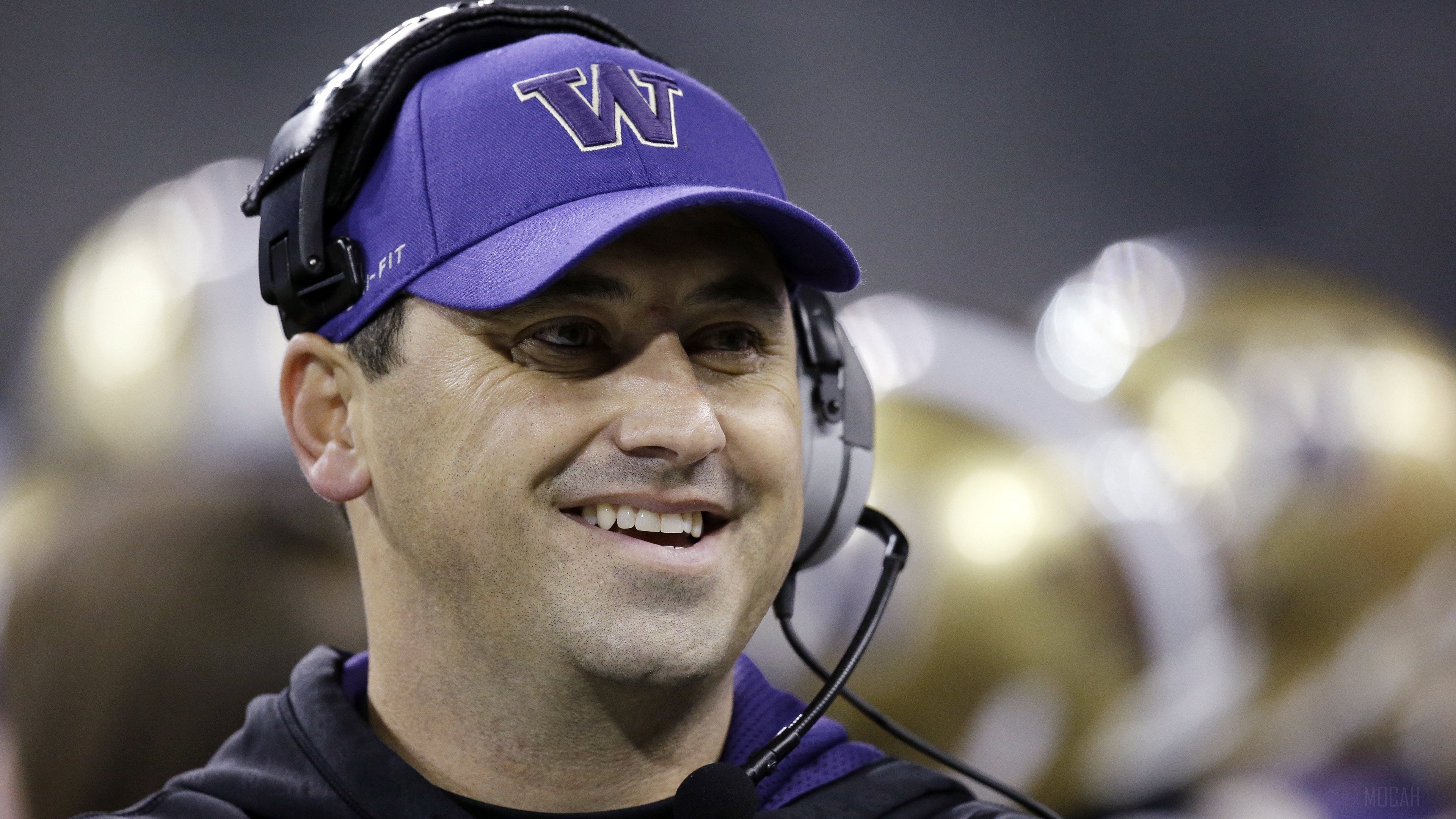 Steve Sarkisian wearing a purple Washington Huskies hat and headset HD Wallpaper