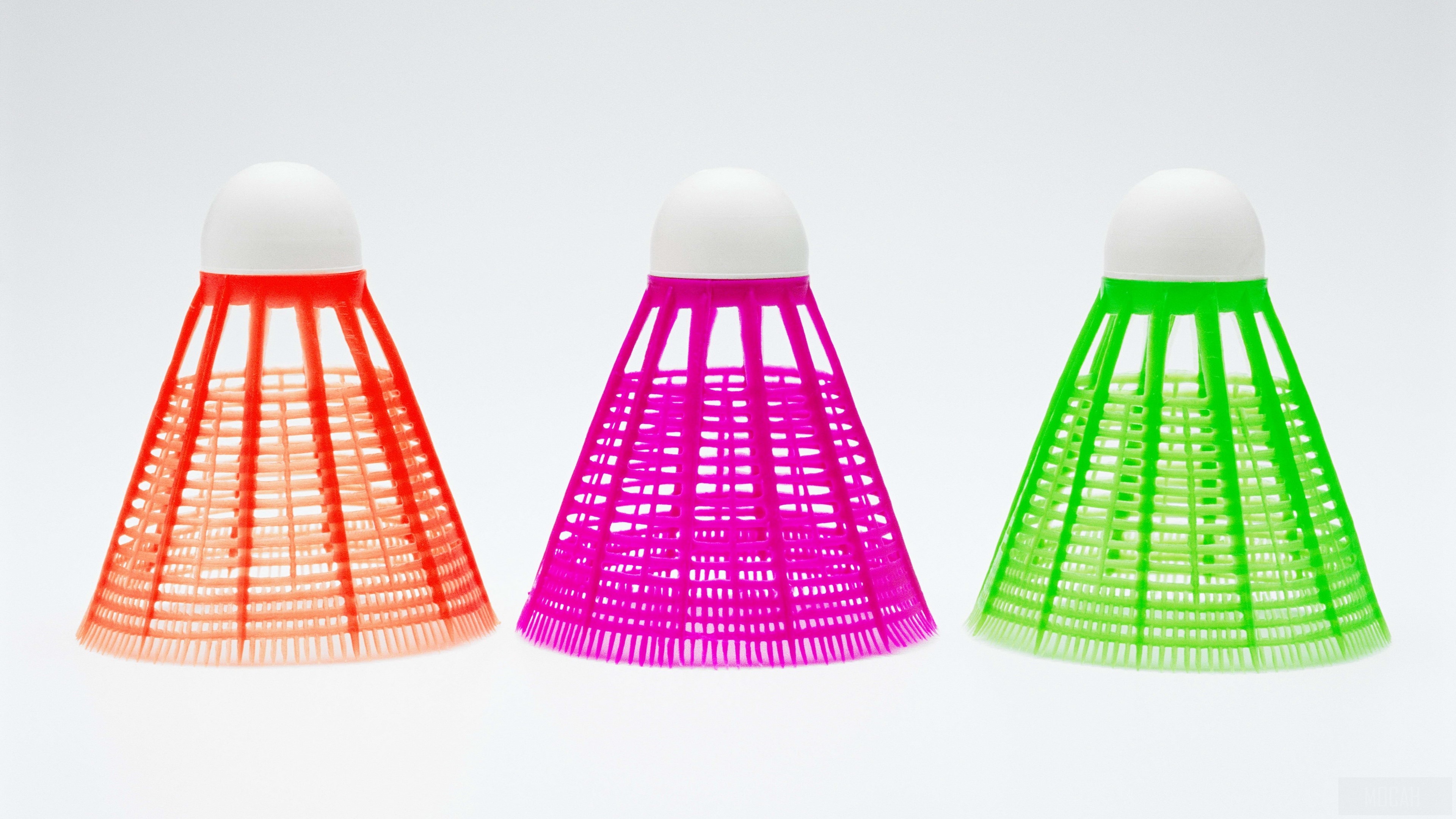 Three colorful shuttlecocks on white background 4K HD Wallpaper