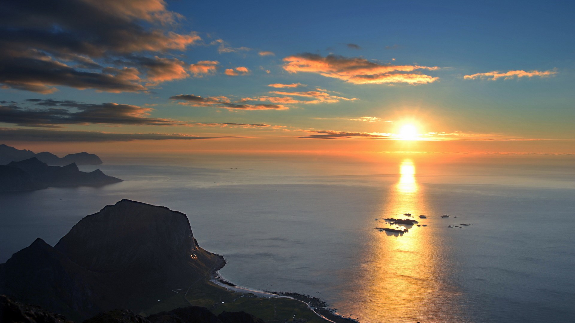 Sunset over the ocean with mountains HD Wallpaper