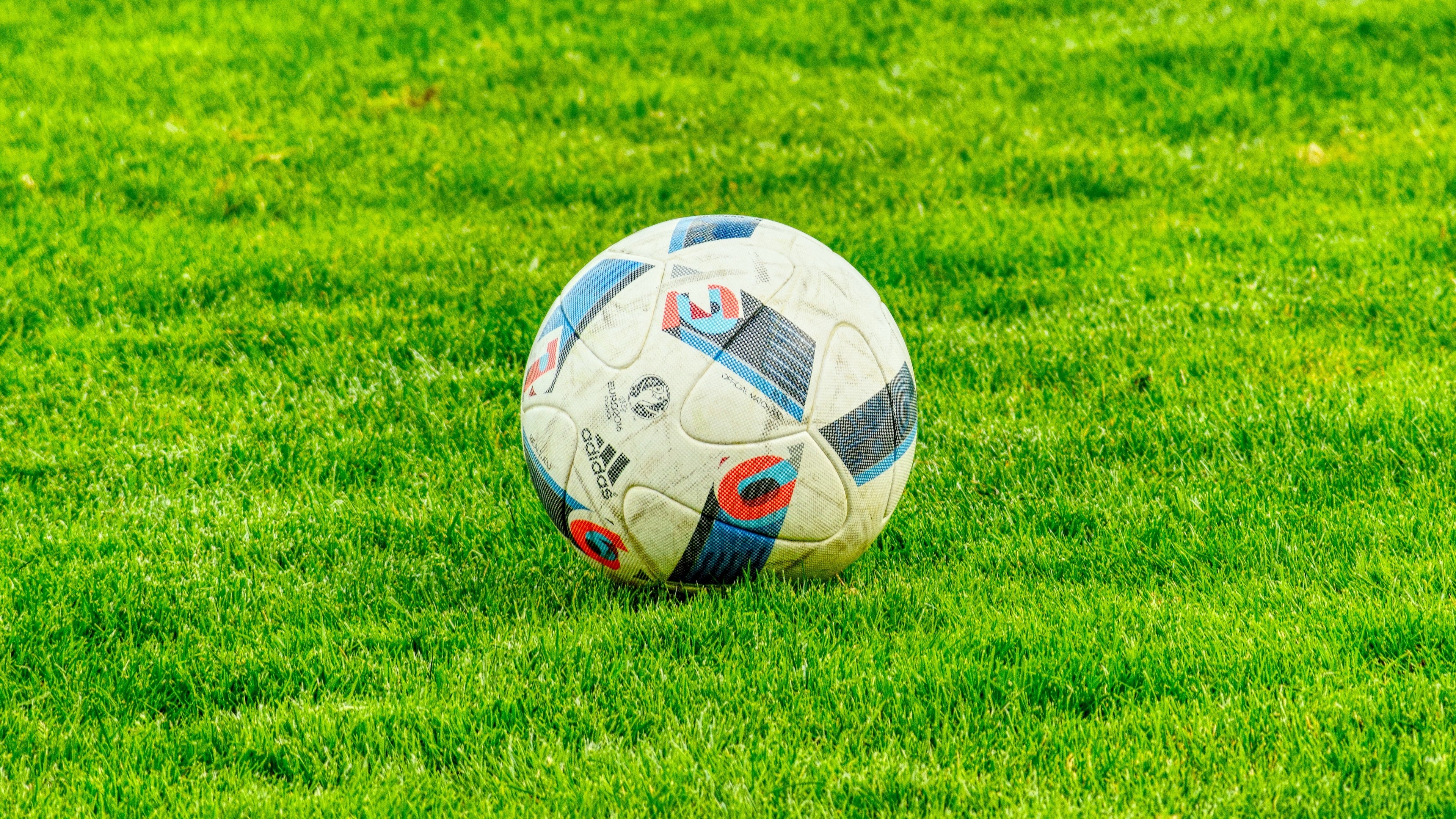 Adidas football on green grass 4K HD Wallpaper