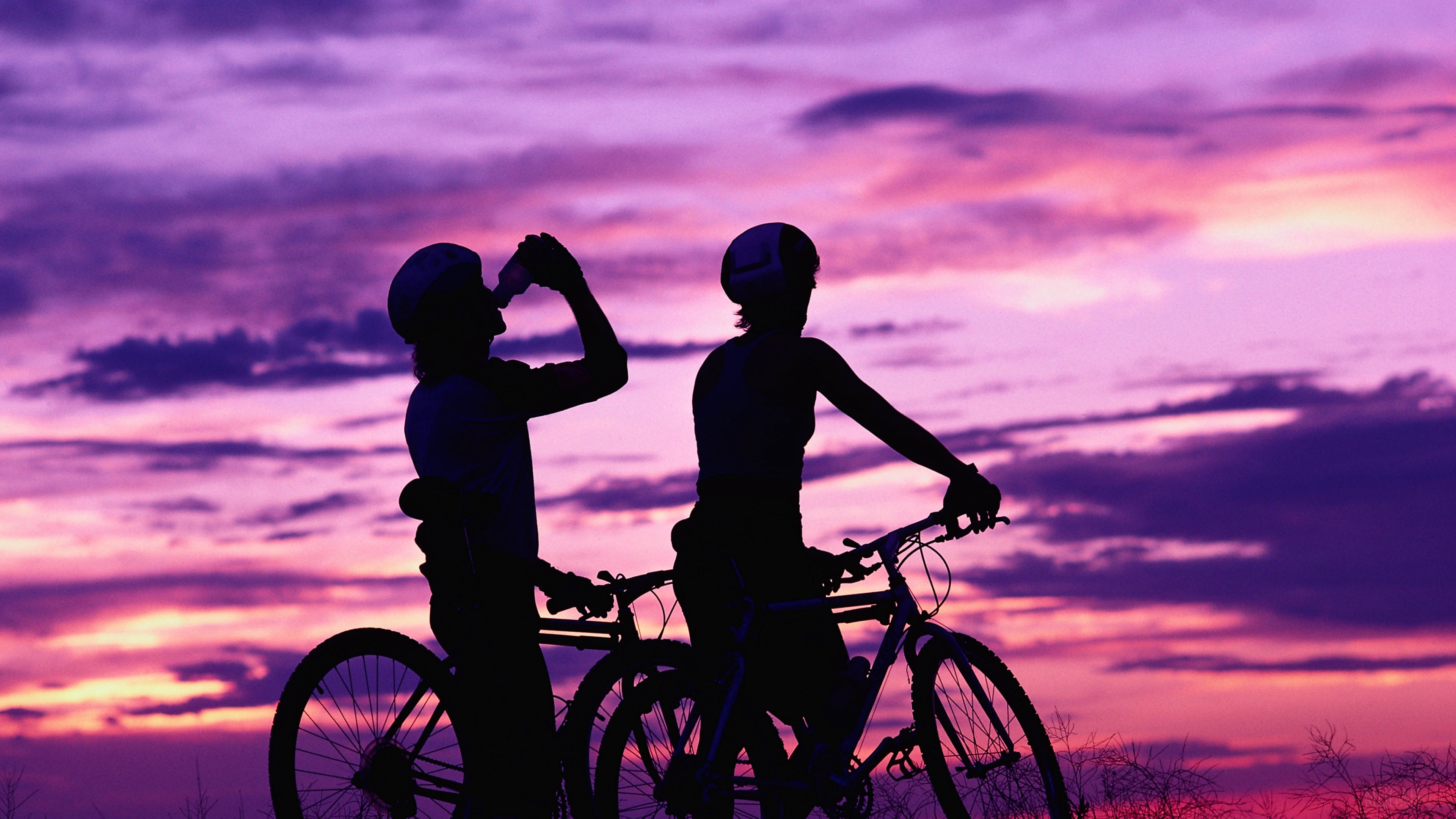 Cyclists enjoying sunset 4K HD Wallpaper