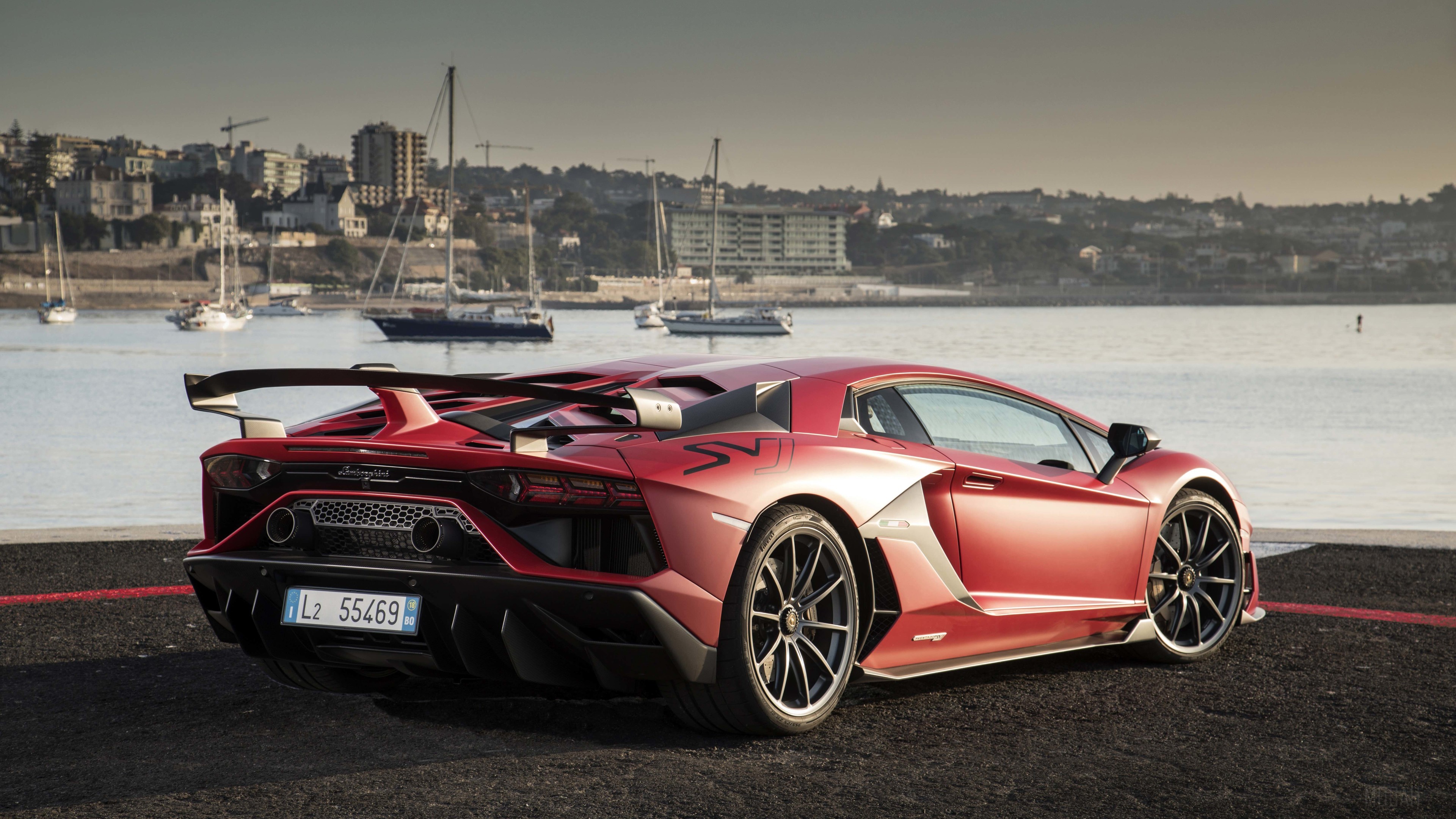 Red Lamborghini Aventador SVJ parked by the water HD Wallpaper