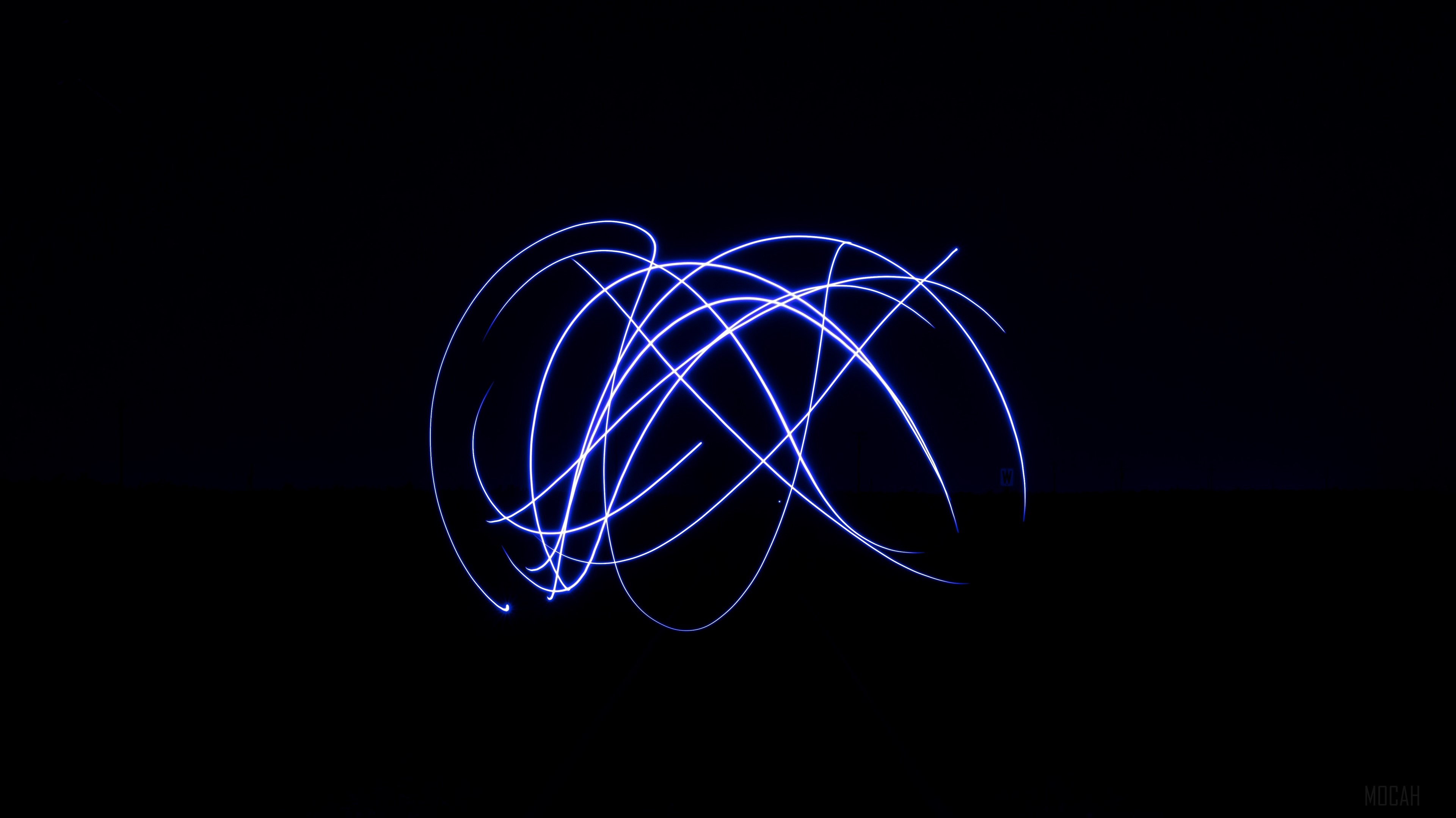 Blue light trails in a dark space HD Wallpaper