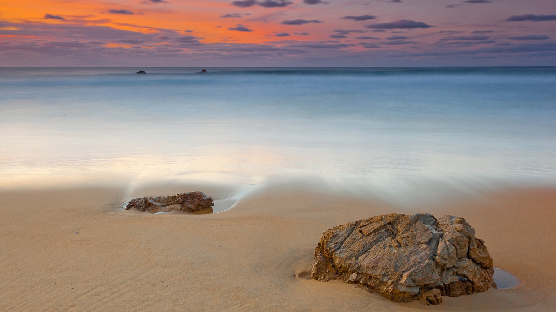 Beach with rocks and ocean at sunset HD Wallpaper