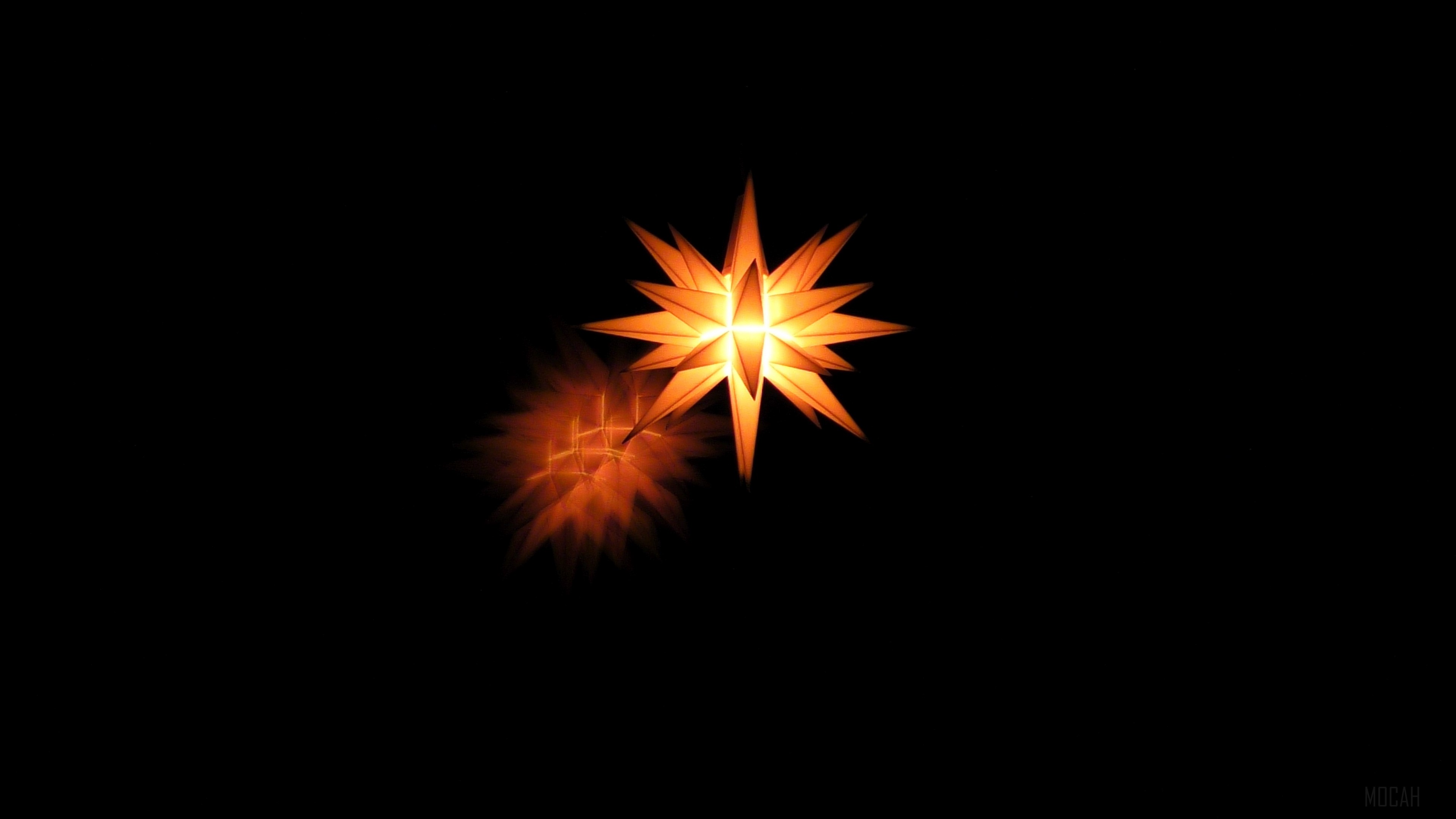 Glowing star shape on dark background 4K HD Wallpaper