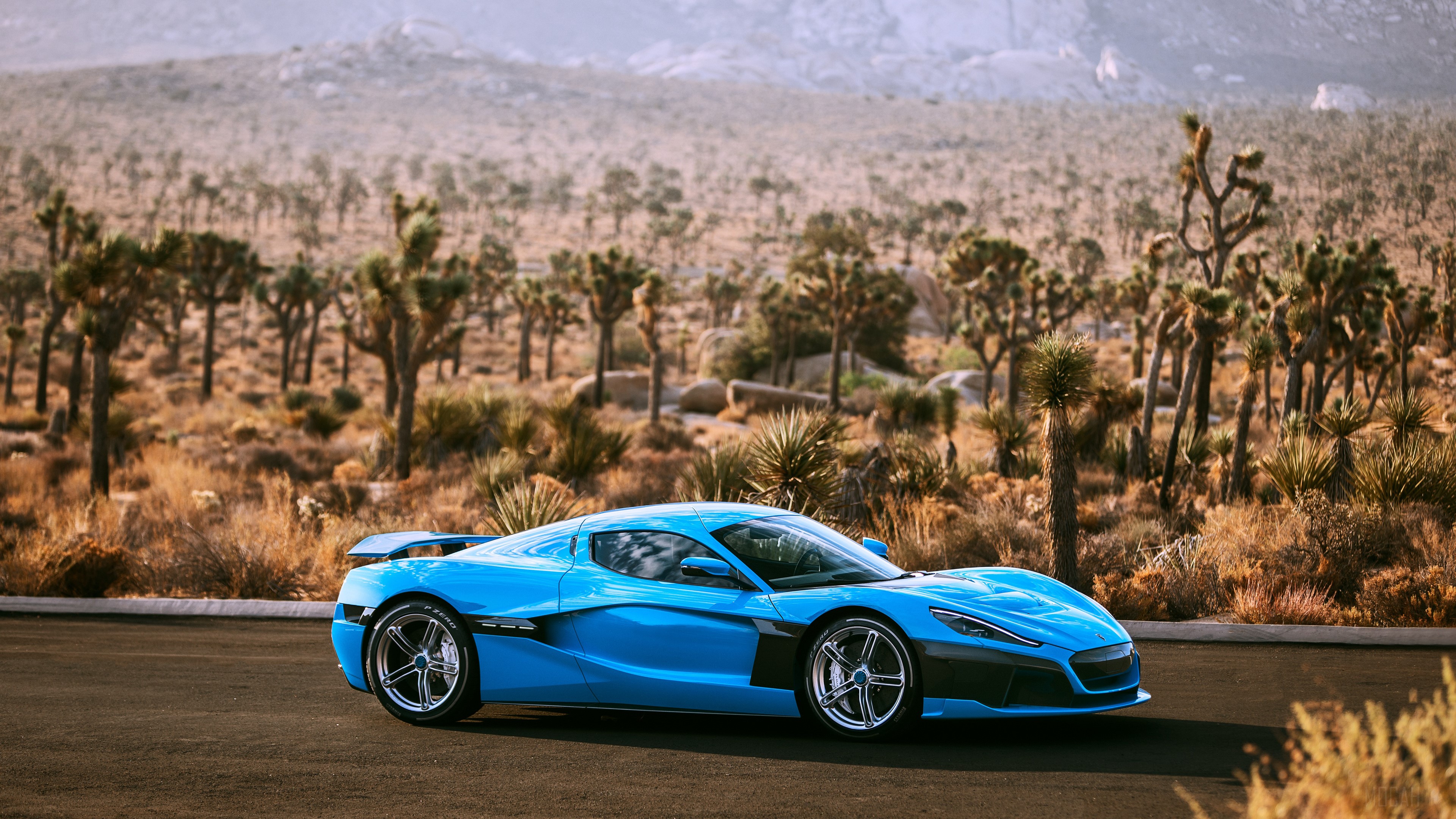 Blue Rimac Nevera electric car in desert landscape HD Wallpaper