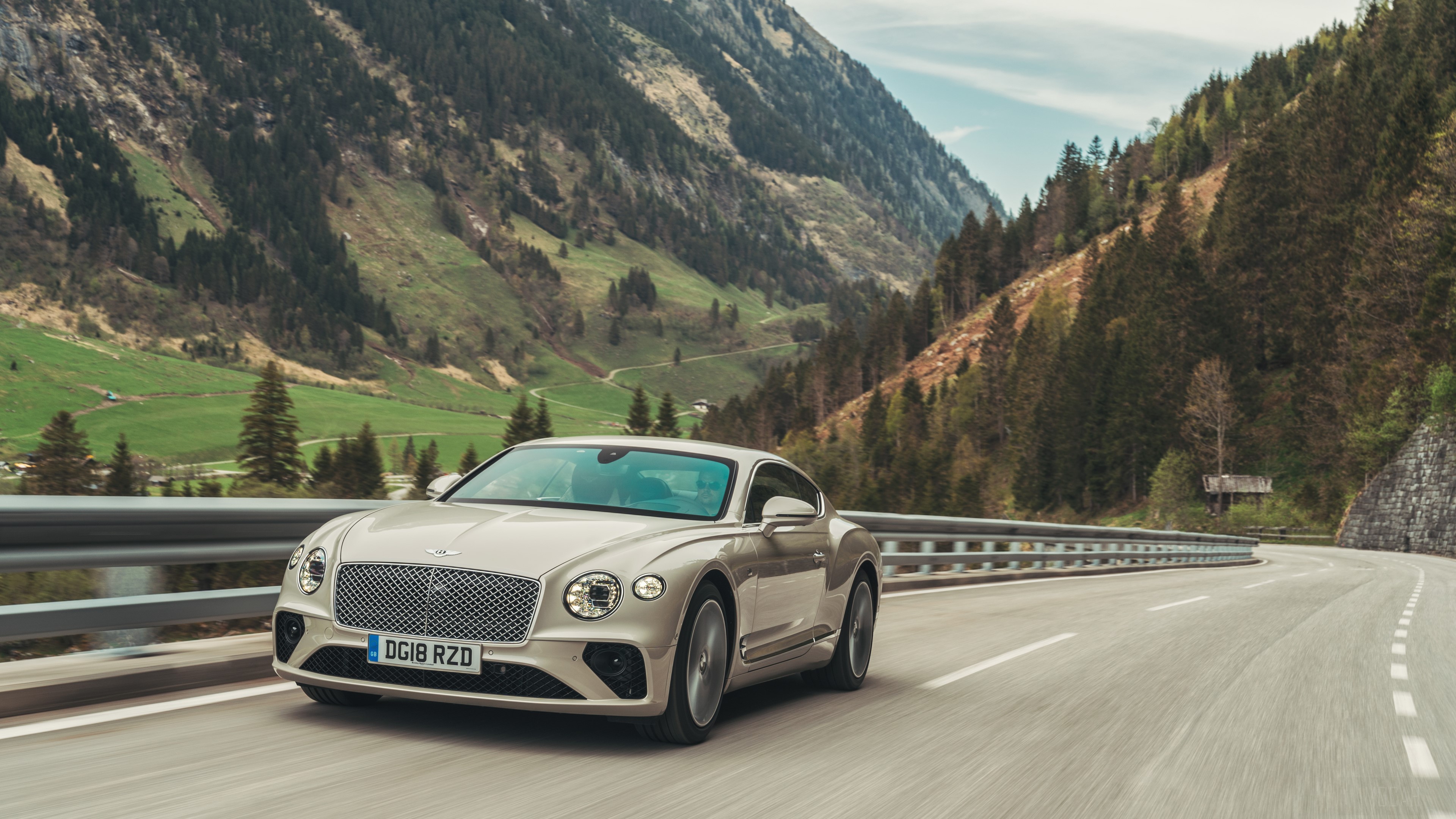 Bentley Continental GT driving on a mountain road HD Wallpaper
