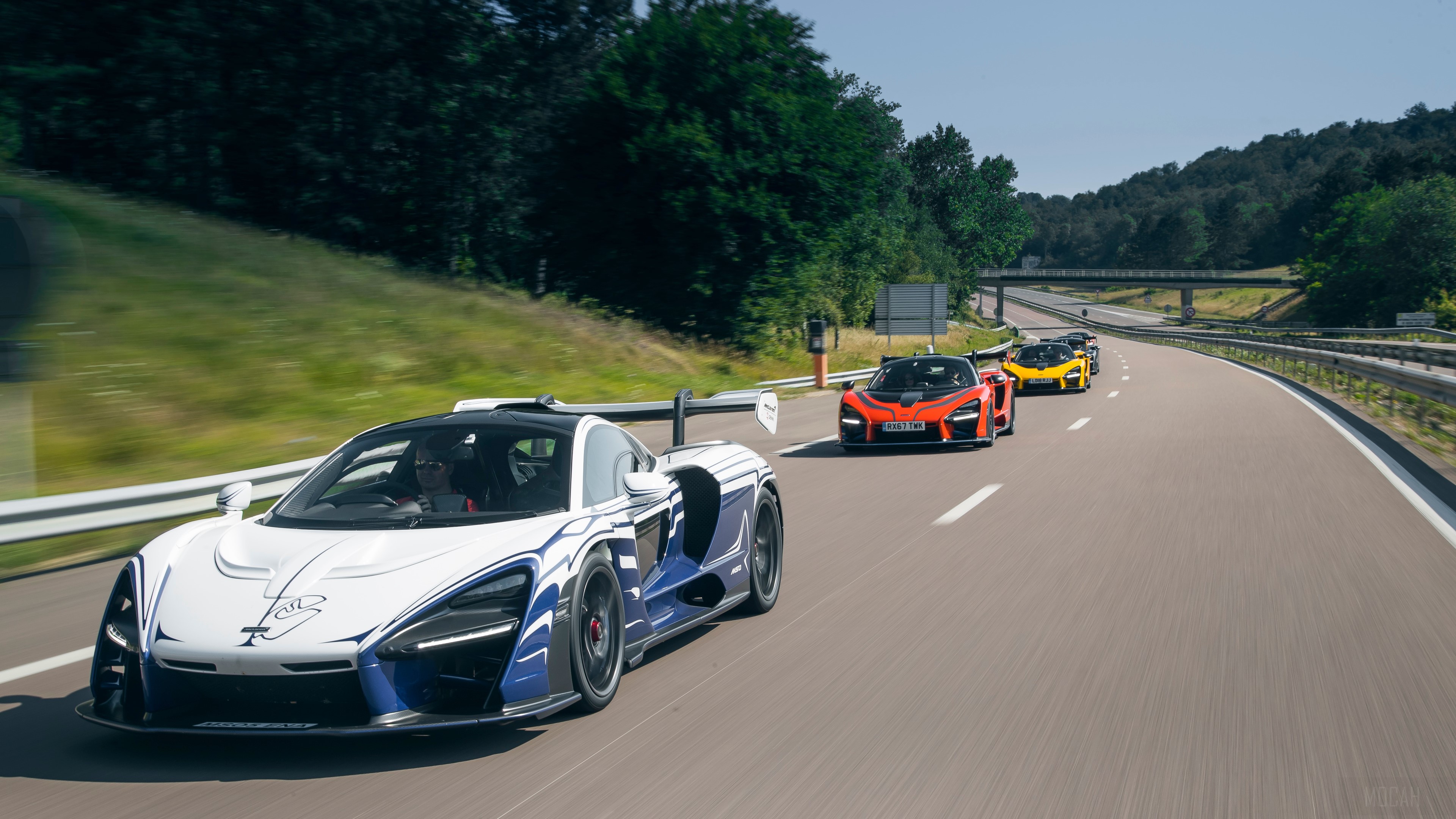 McLaren Senna cars driving on a highway HD Wallpaper