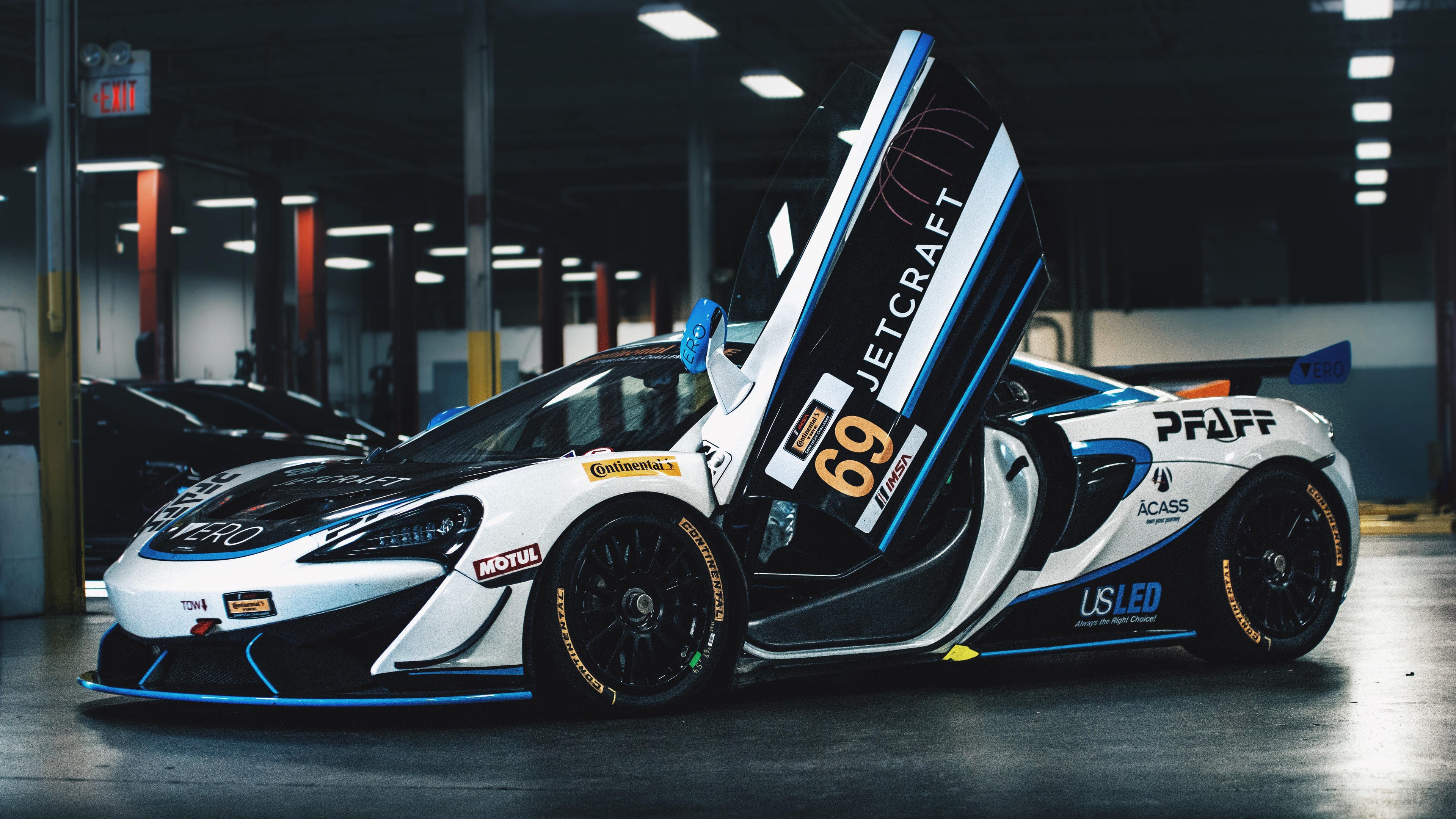 McLaren 570S GT4 race car with doors open HD Wallpaper