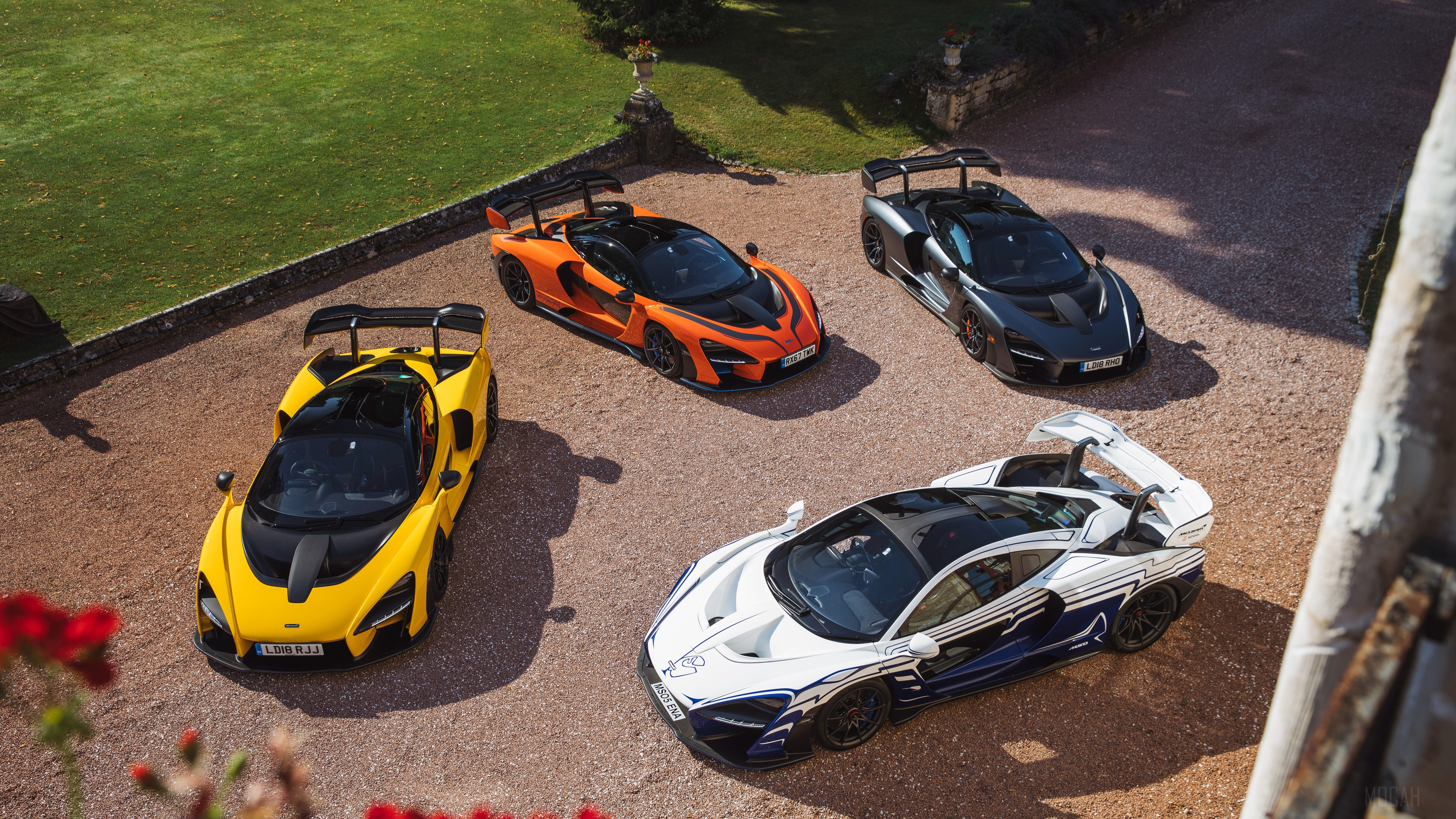 Four McLaren Senna cars in a gravel driveway HD Wallpaper
