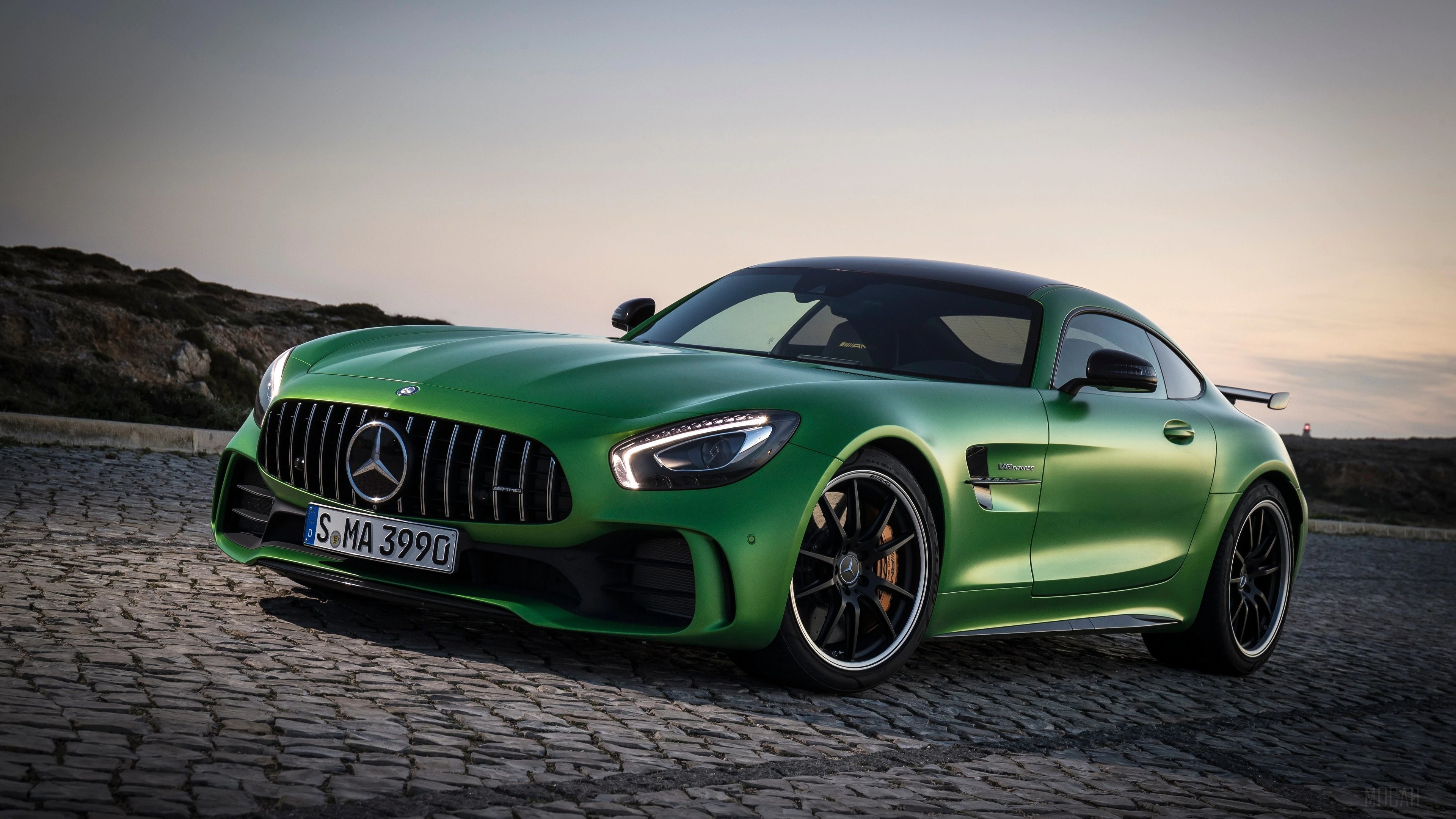 Green Mercedes-Benz AMG GT R on cobblestone road HD Wallpaper