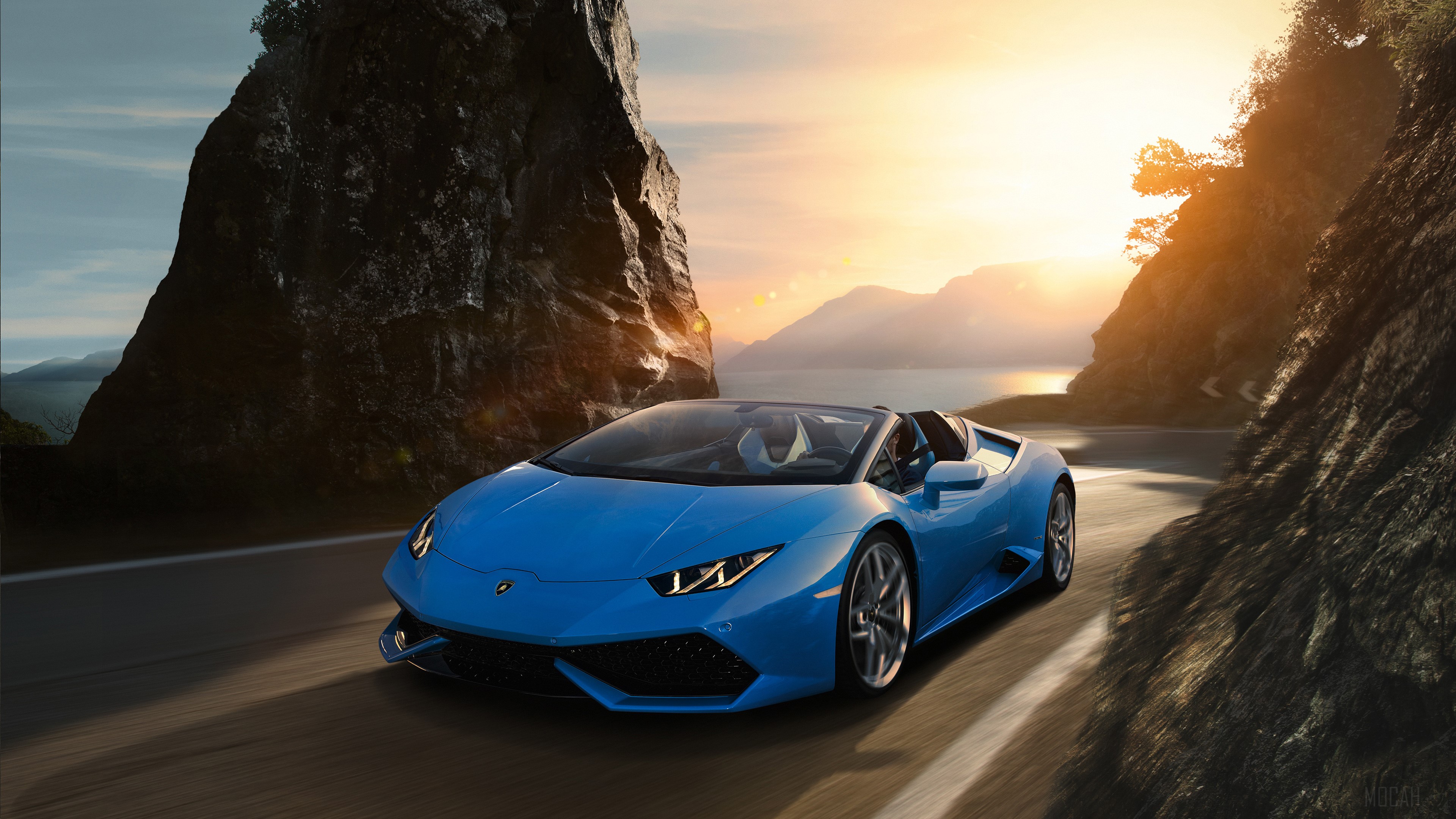 Blue Lamborghini Huracan driving on a coastal road at sunset HD Wallpaper