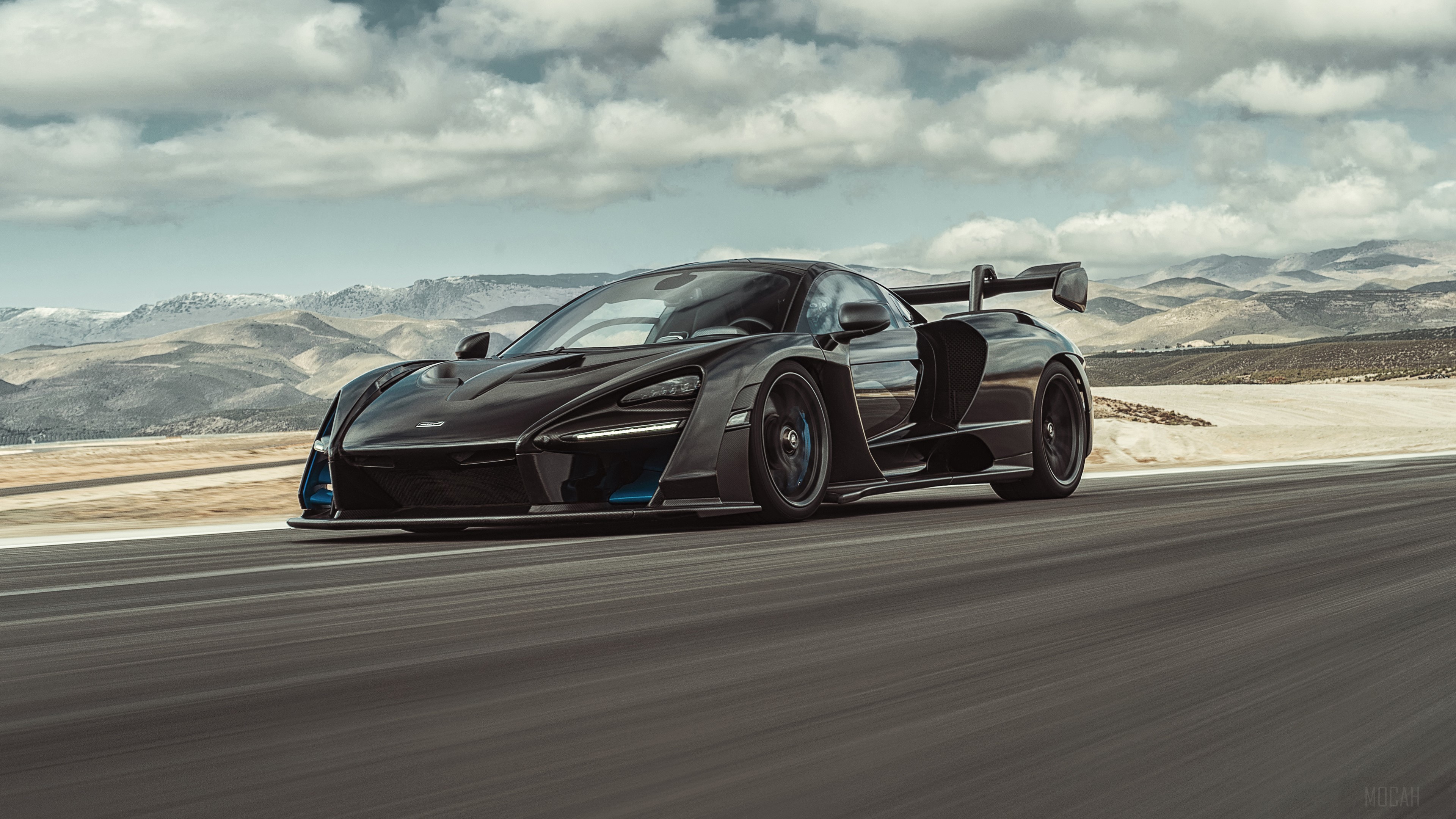 Black McLaren Senna driving on a road HD Wallpaper