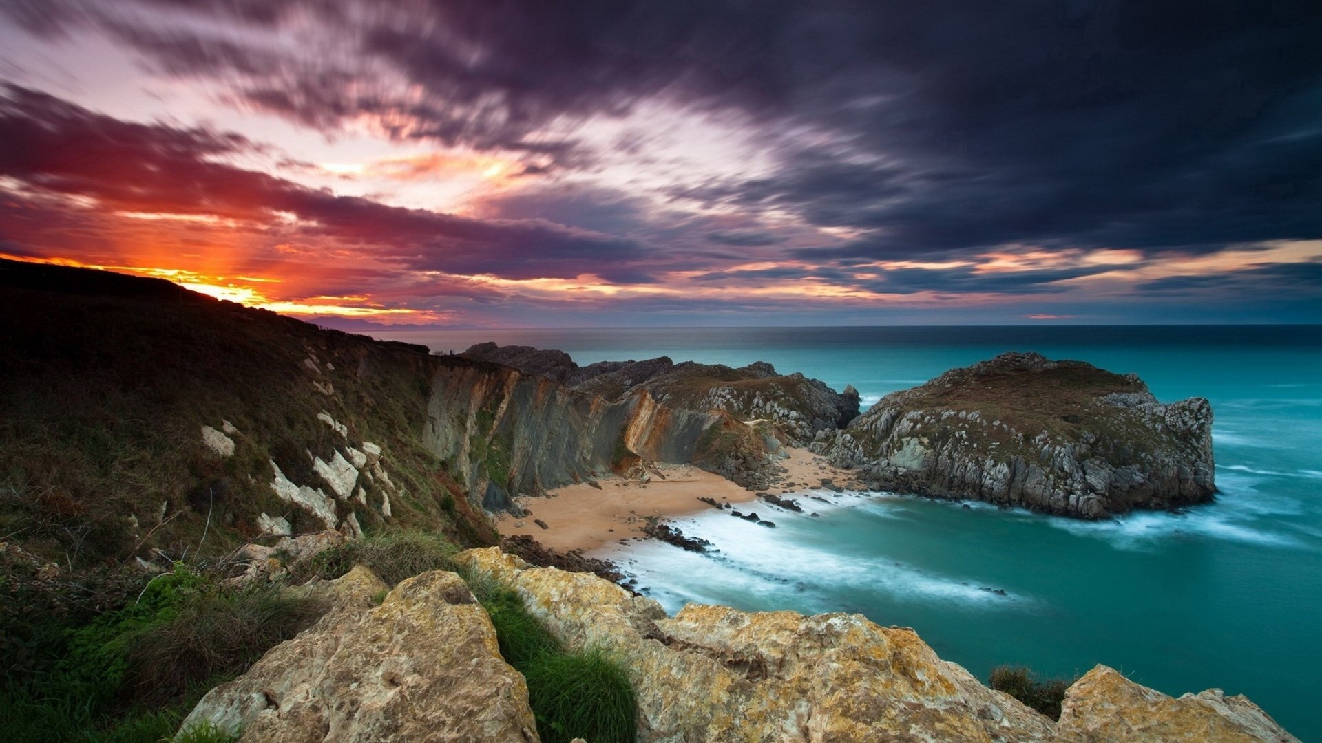 Sunset over rocky coastline and ocean HD Wallpaper