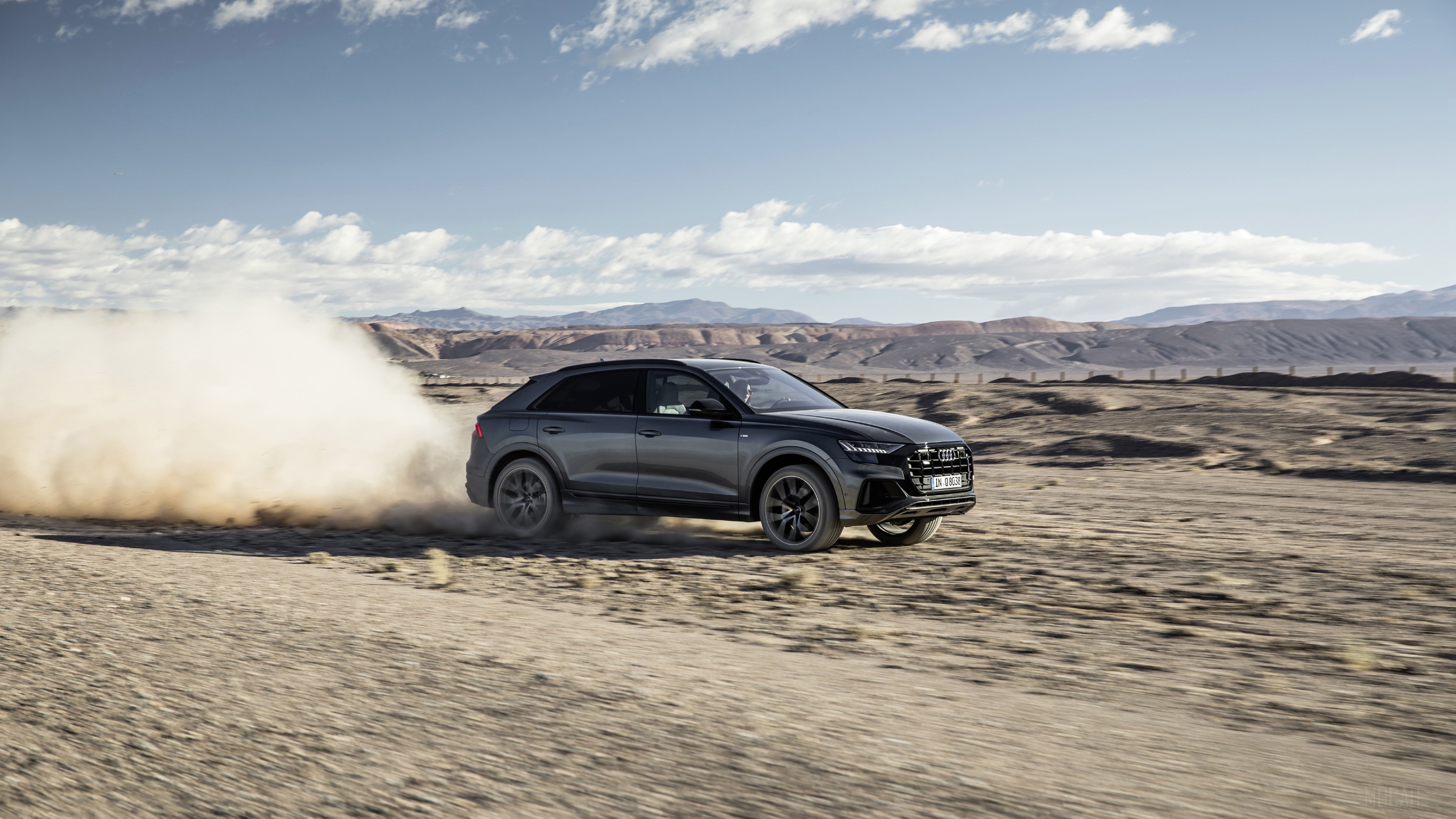 Audi Q8 driving on a dirt road HD Wallpaper