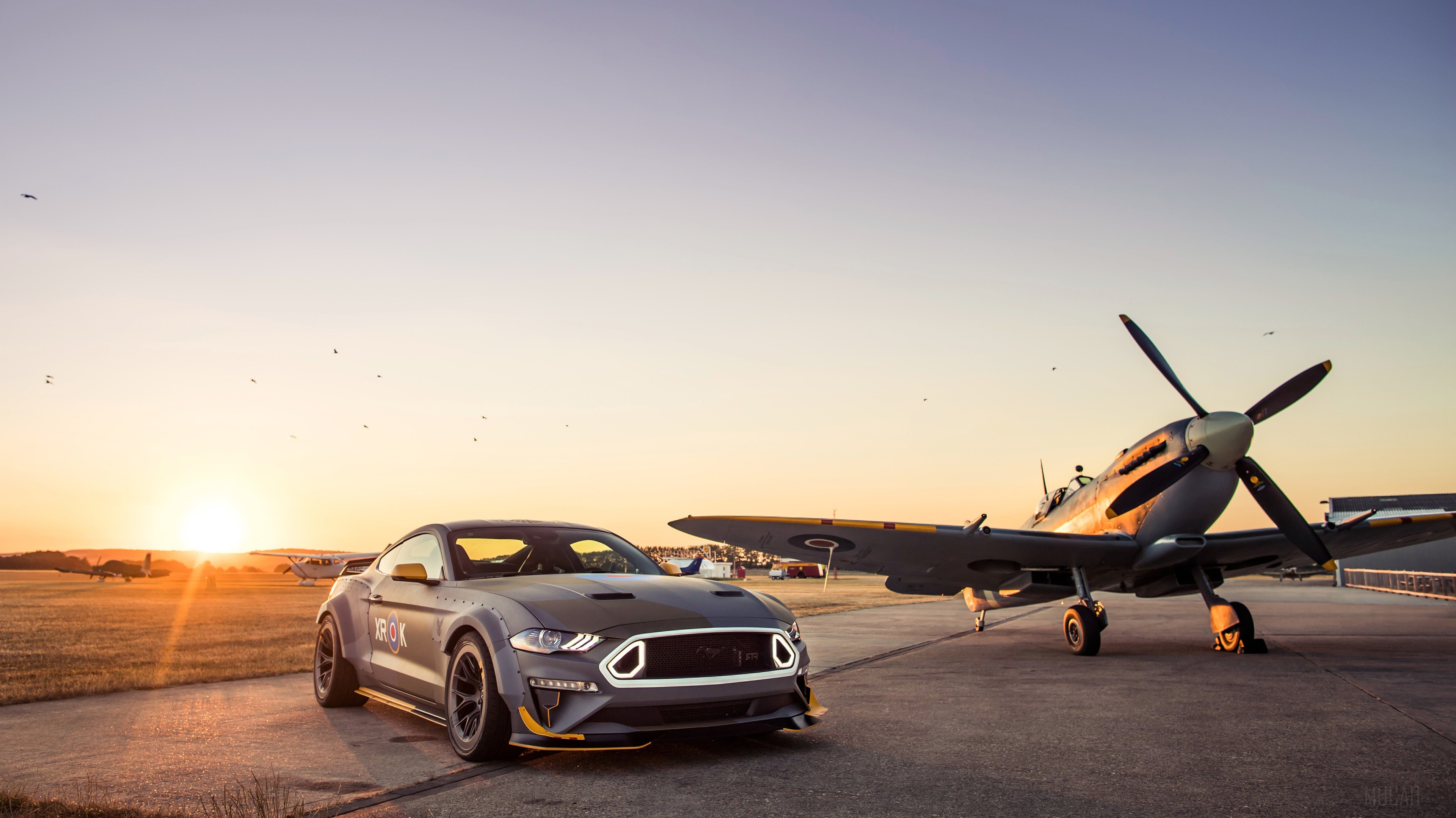 Ford Mustang GT and Spitfire airplane at sunset HD Wallpaper