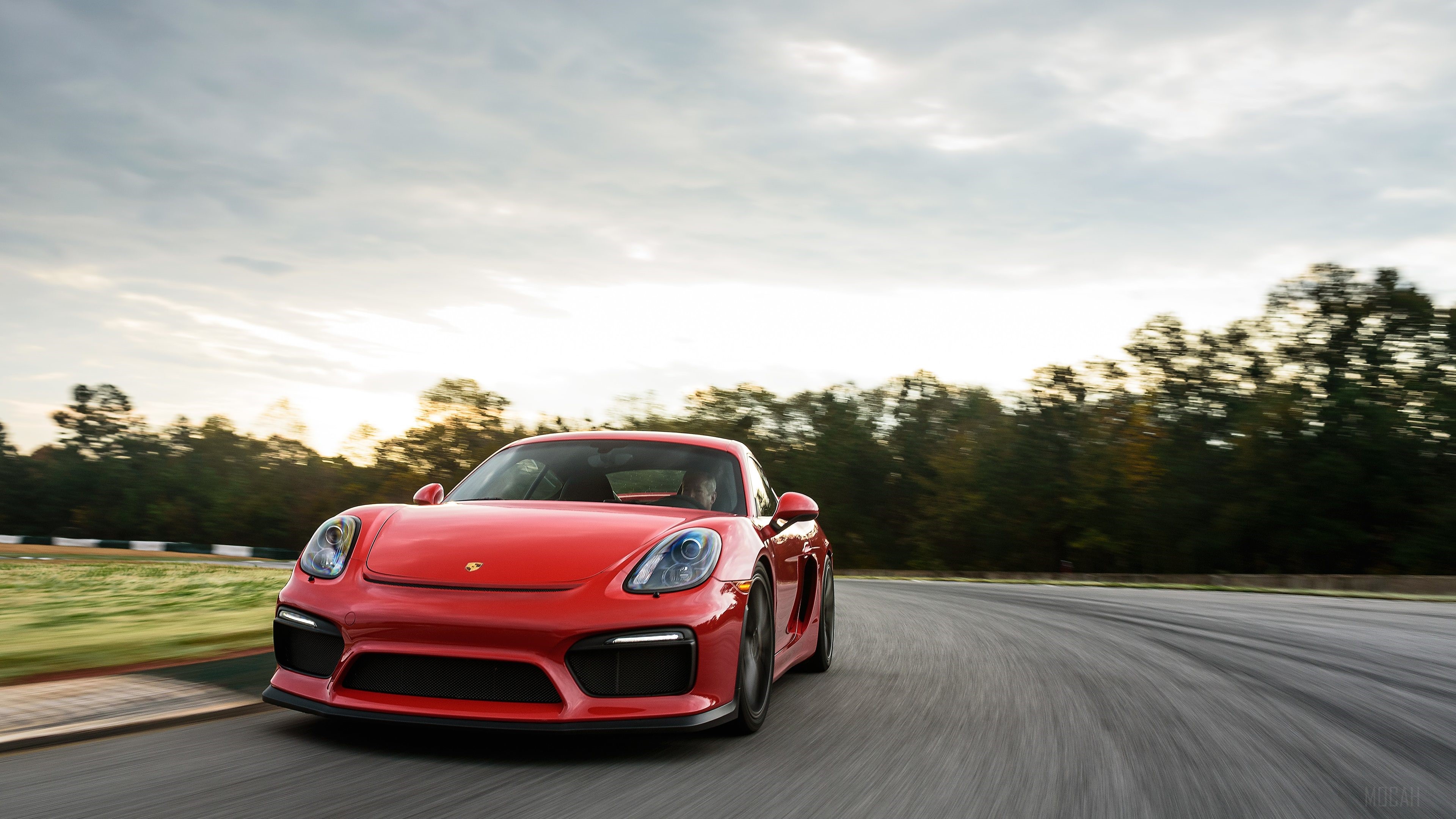 Red Porsche Cayman GT4 on a Race Track HD Wallpaper