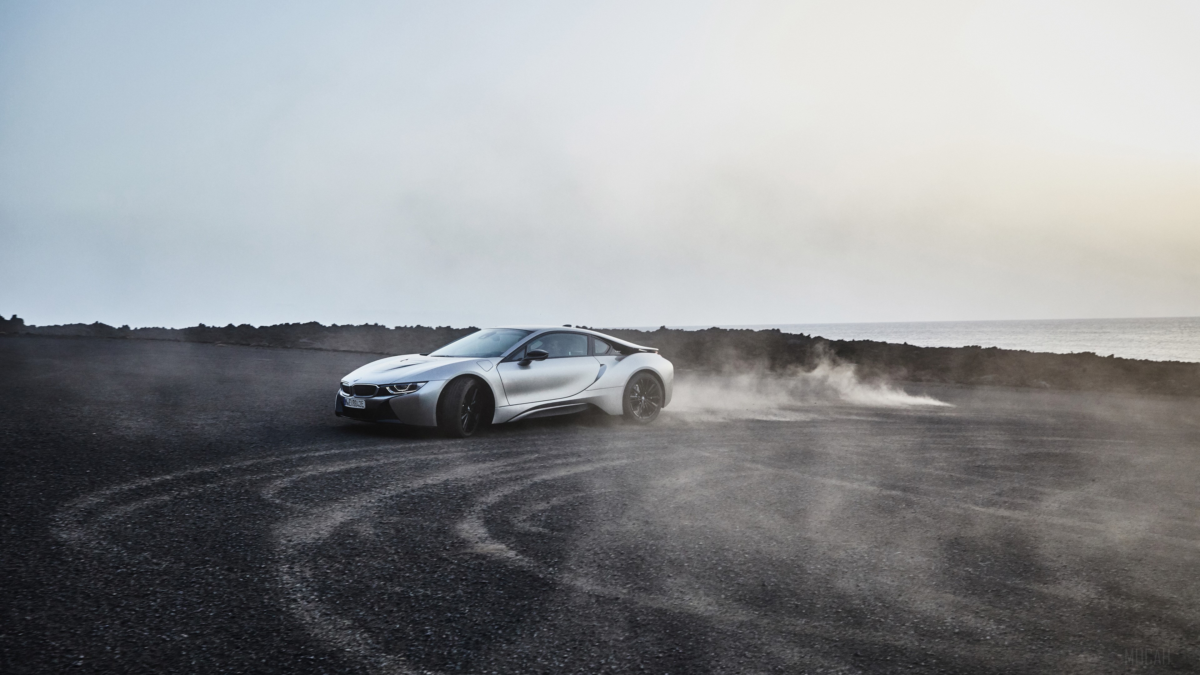 Silver BMW i8 Coupe drifting on dark terrain HD Wallpaper