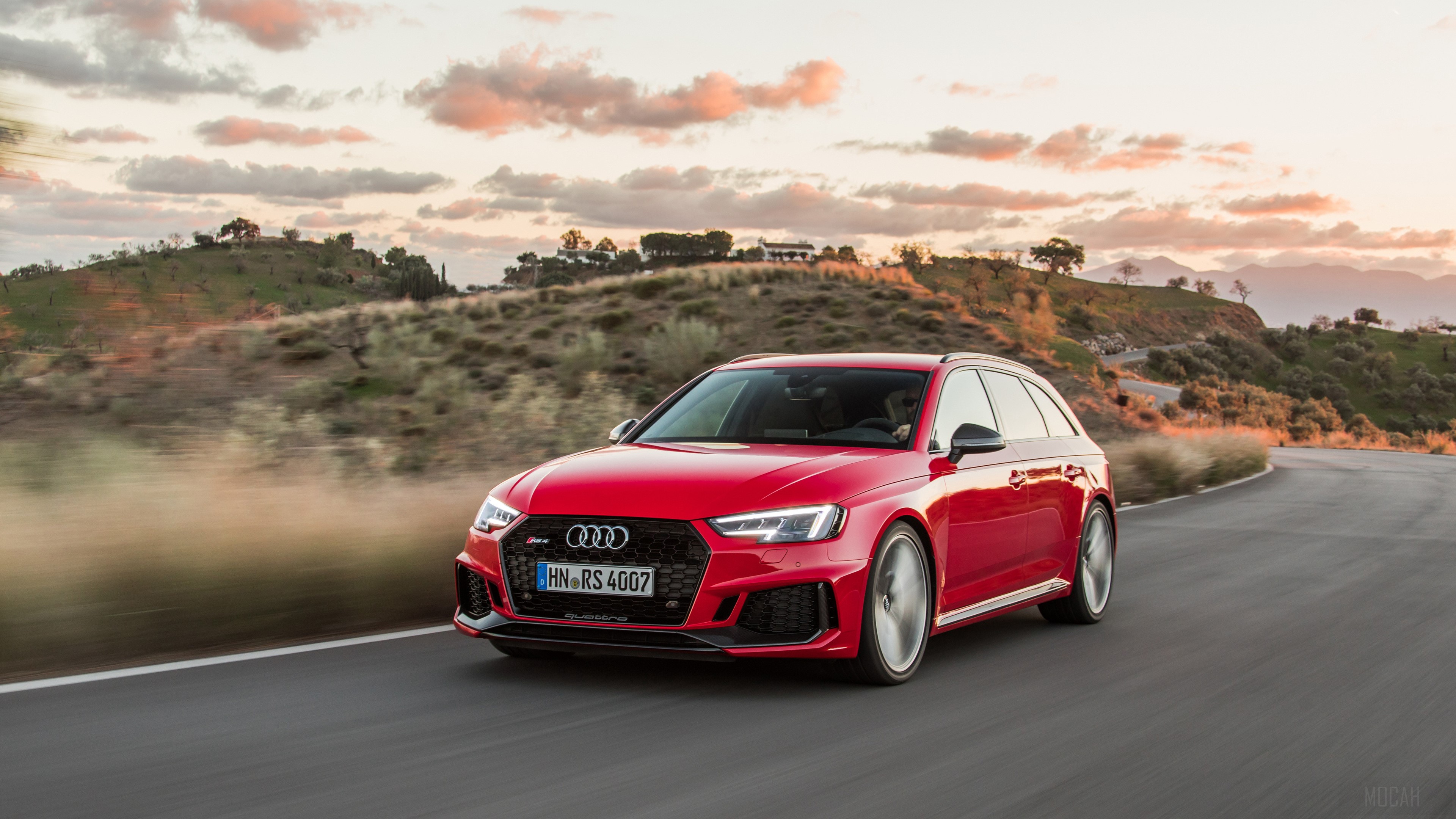 Red Audi RS 4 Avant driving on a road HD Wallpaper