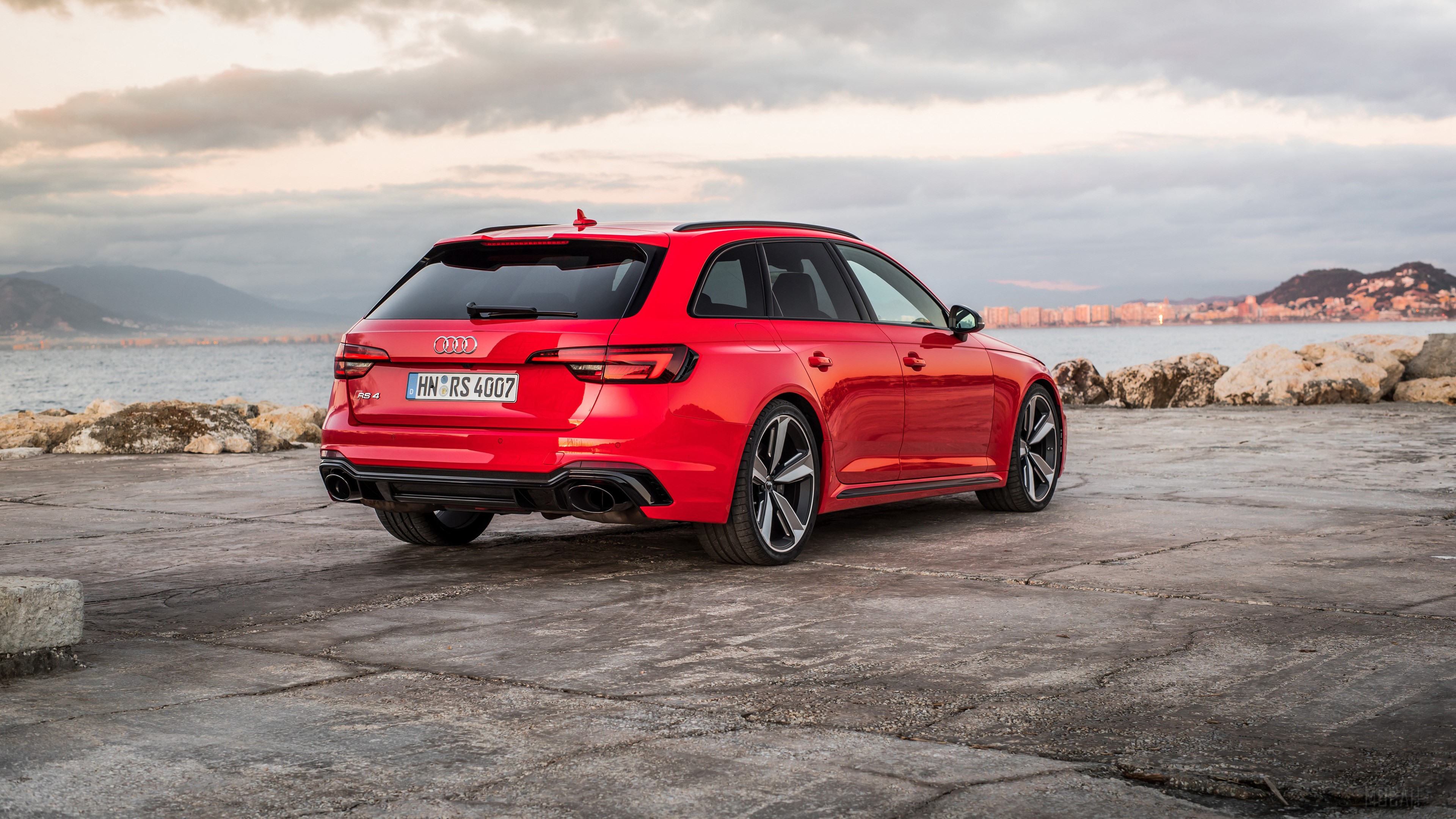 Red Audi RS 4 Avant parked by the sea HD Wallpaper