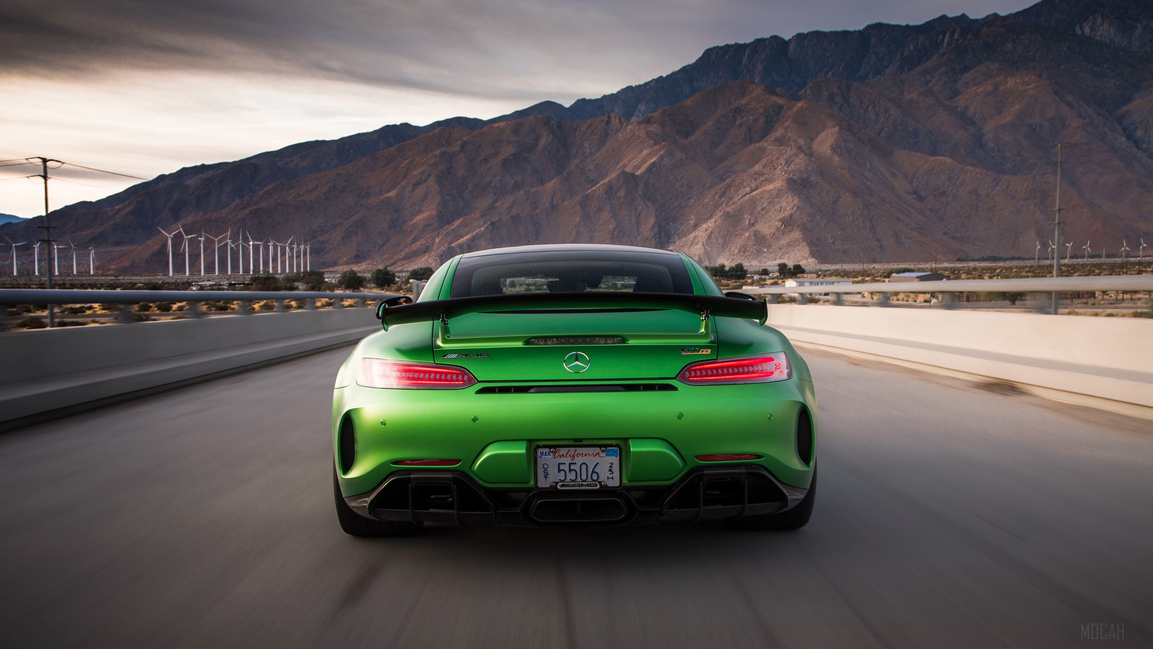 Green Mercedes-AMG GT R driving on a road with windmills HD Wallpaper
