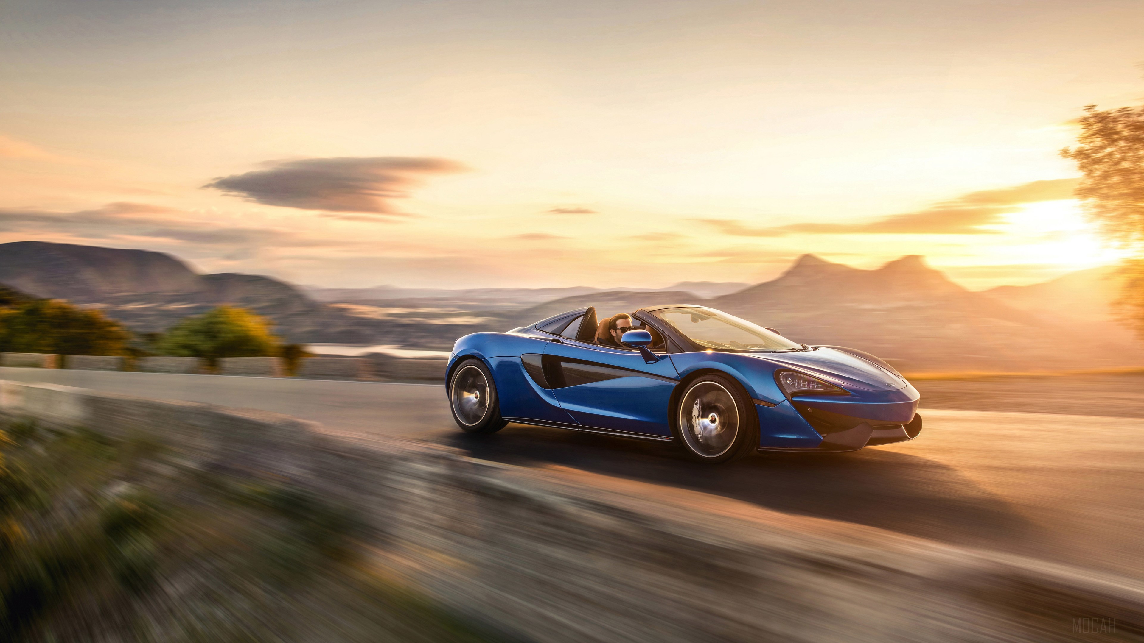 Blue McLaren 570S Spider driving at sunset HD Wallpaper