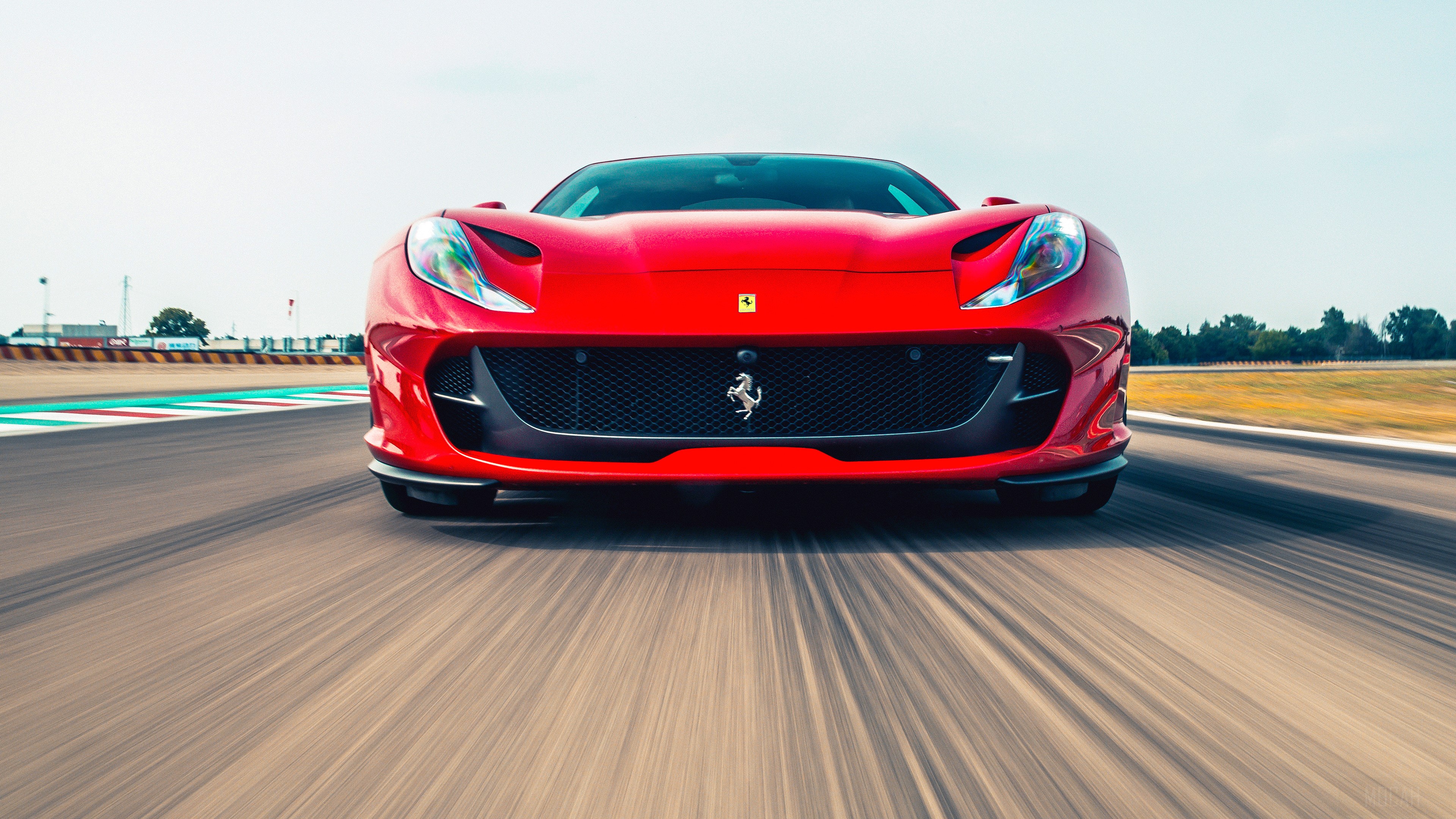 Red Ferrari 812 Superfast on a Racetrack HD Wallpaper