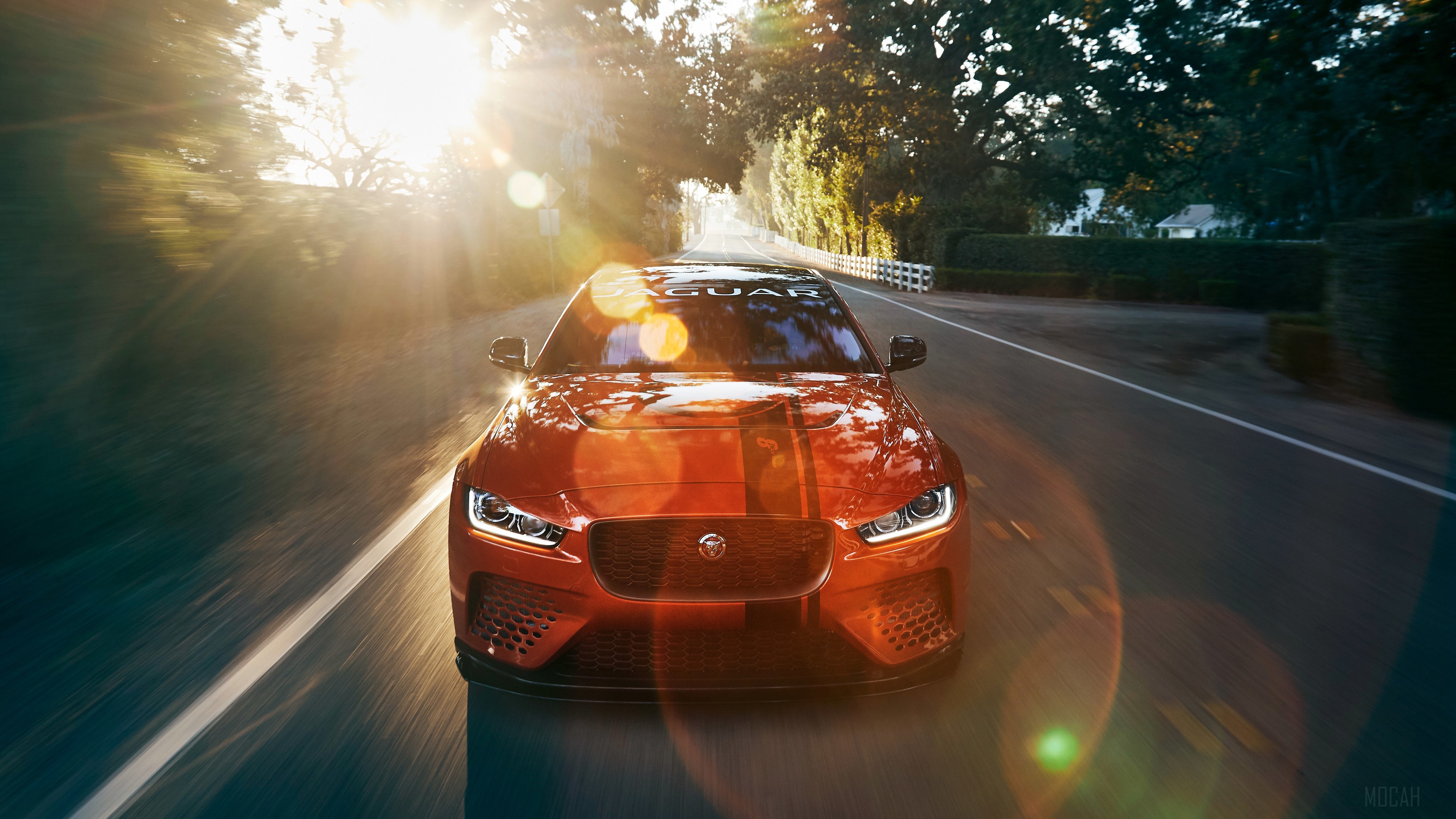 Orange Jaguar XE SV Project 8 driving on road HD Wallpaper
