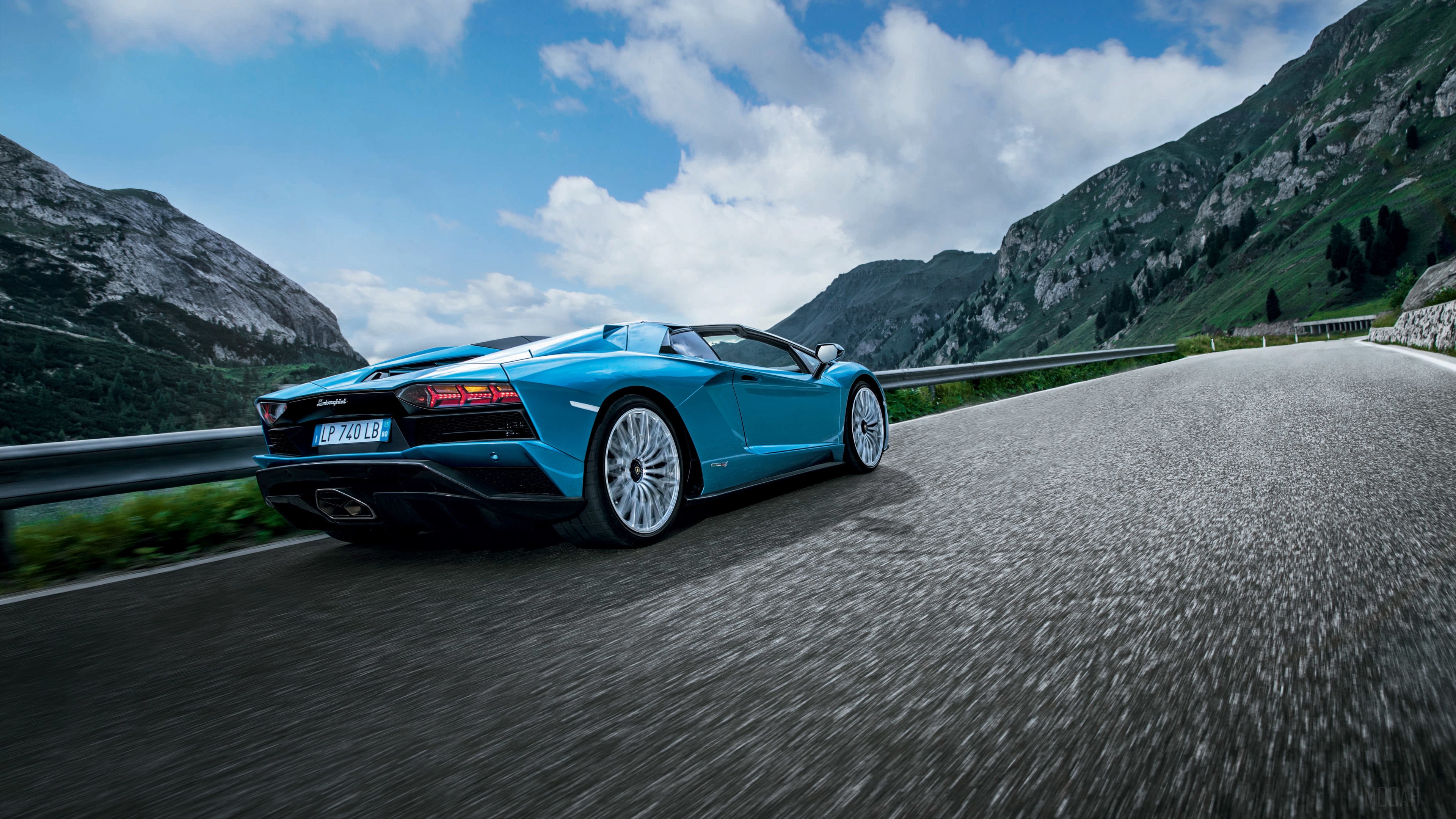 Blue Lamborghini Aventador S Roadster driving on mountain road HD Wallpaper