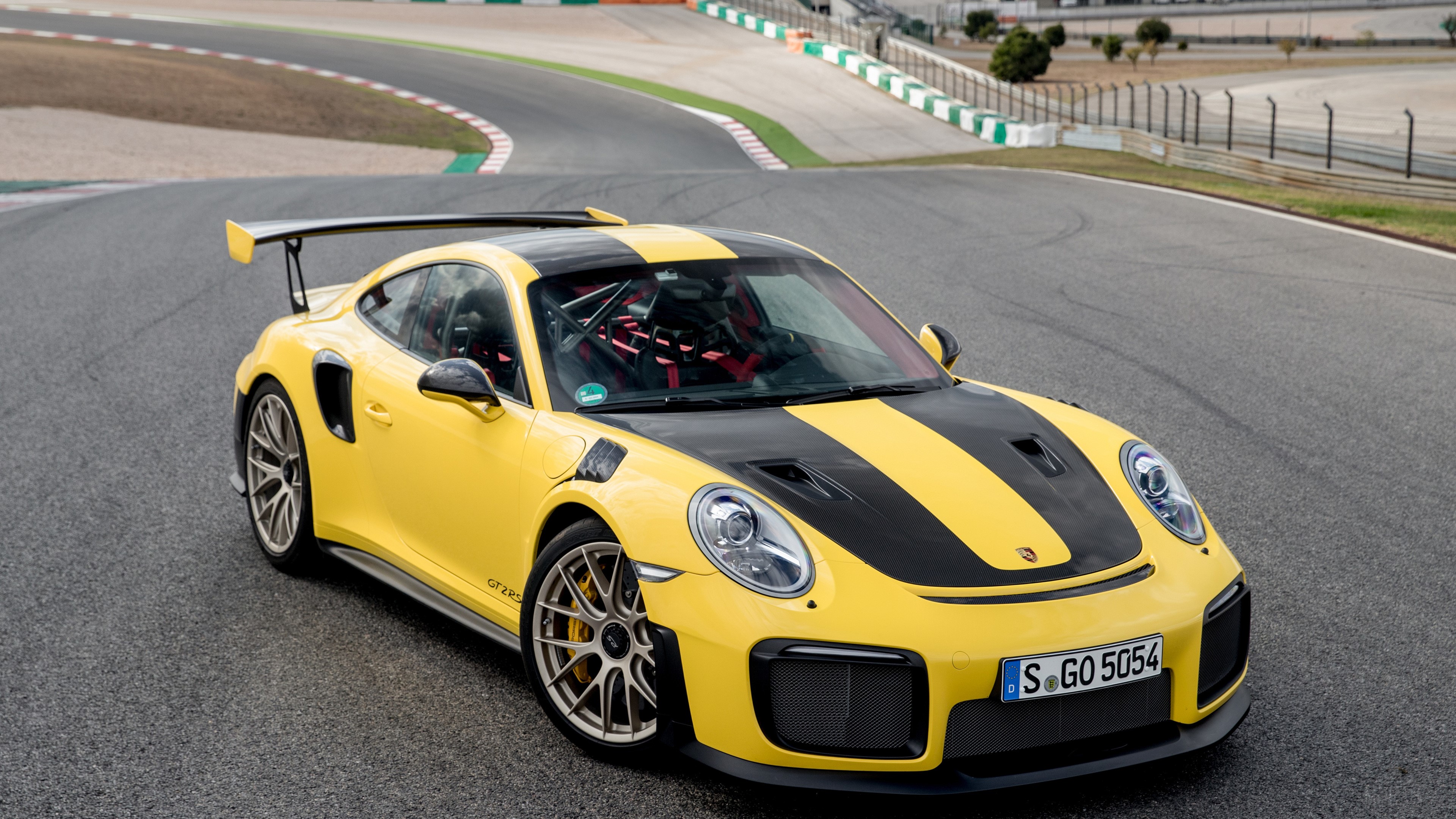 Yellow Porsche 911 GT2 RS on a race track HD Wallpaper