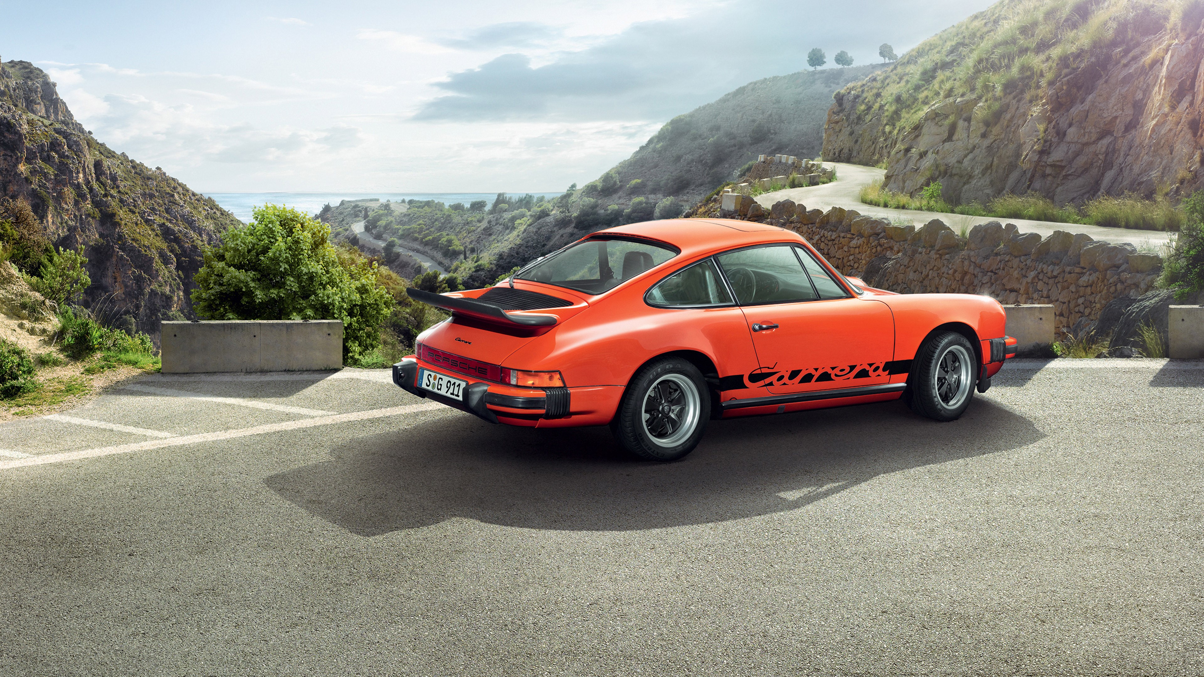 Orange Porsche 911 Carrera on a Mountain Road HD Wallpaper
