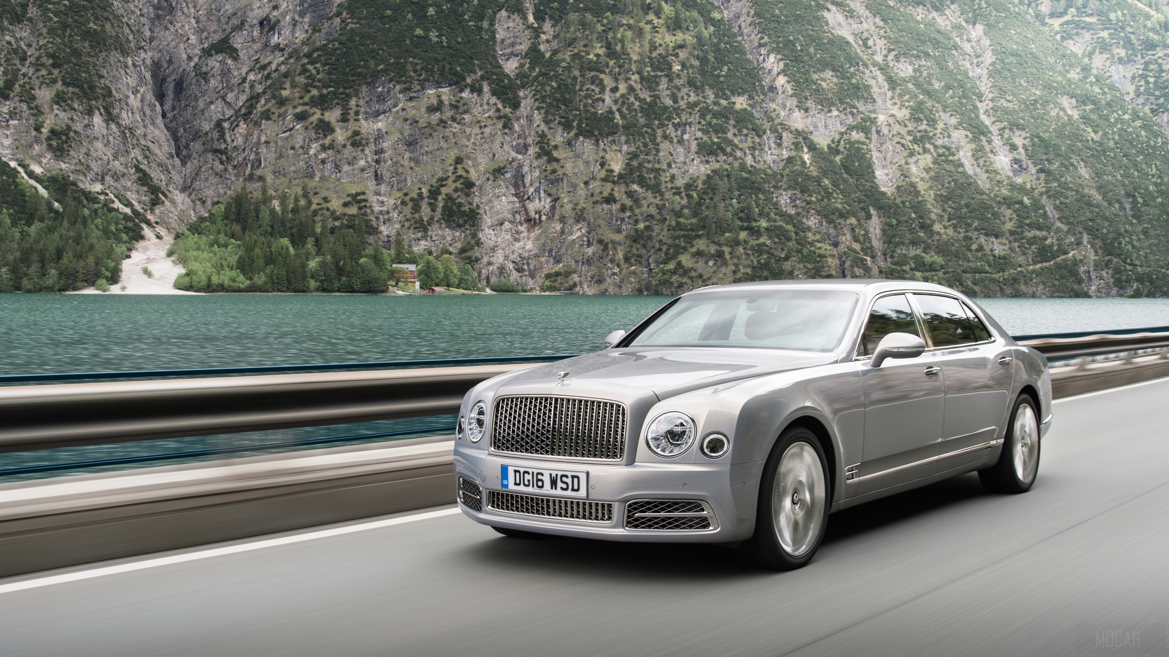 Bentley Mulsanne driving on a road by a lake HD Wallpaper