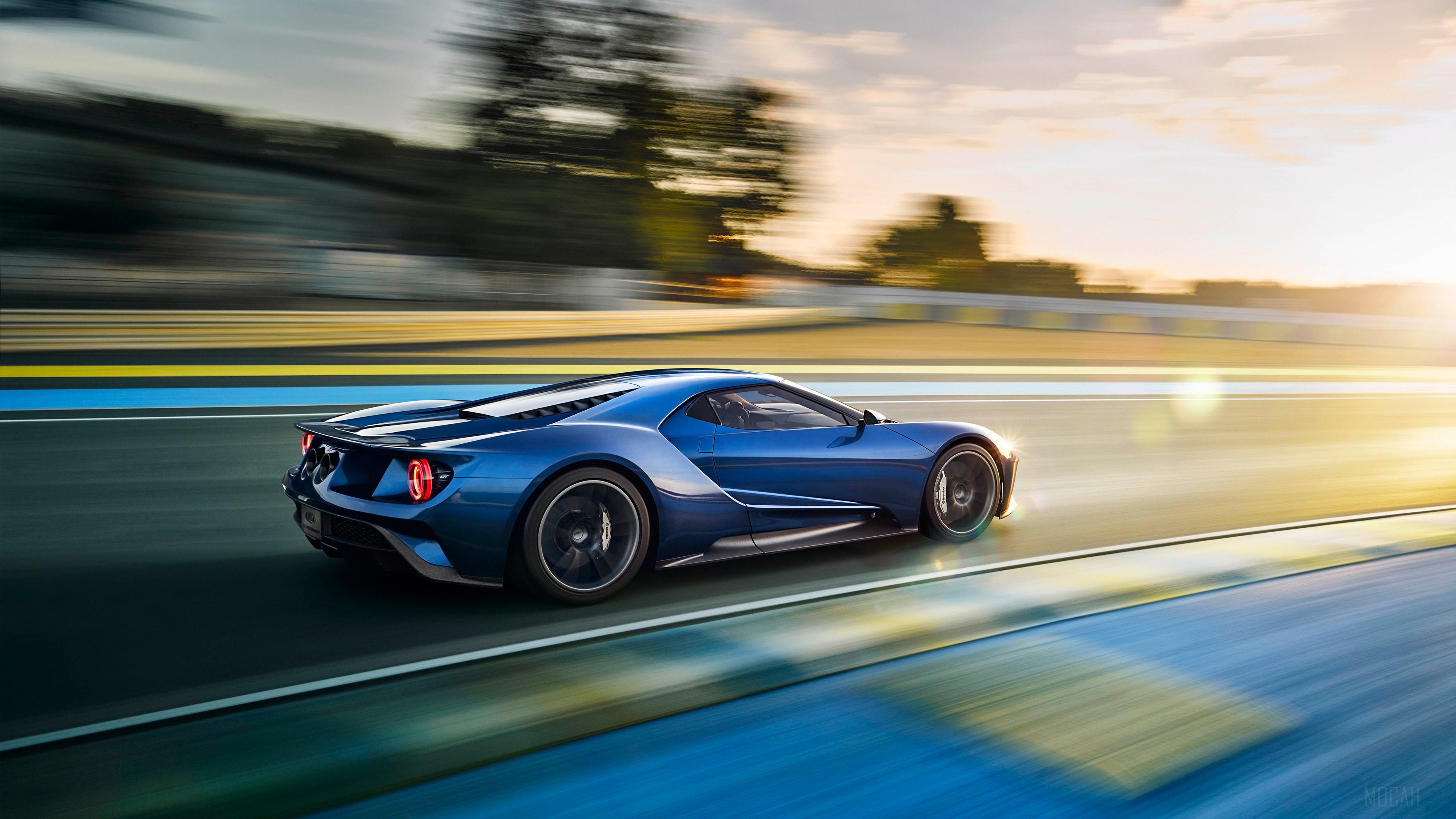 Blue 2017 Ford GT driving on a race track 4K HD Wallpaper