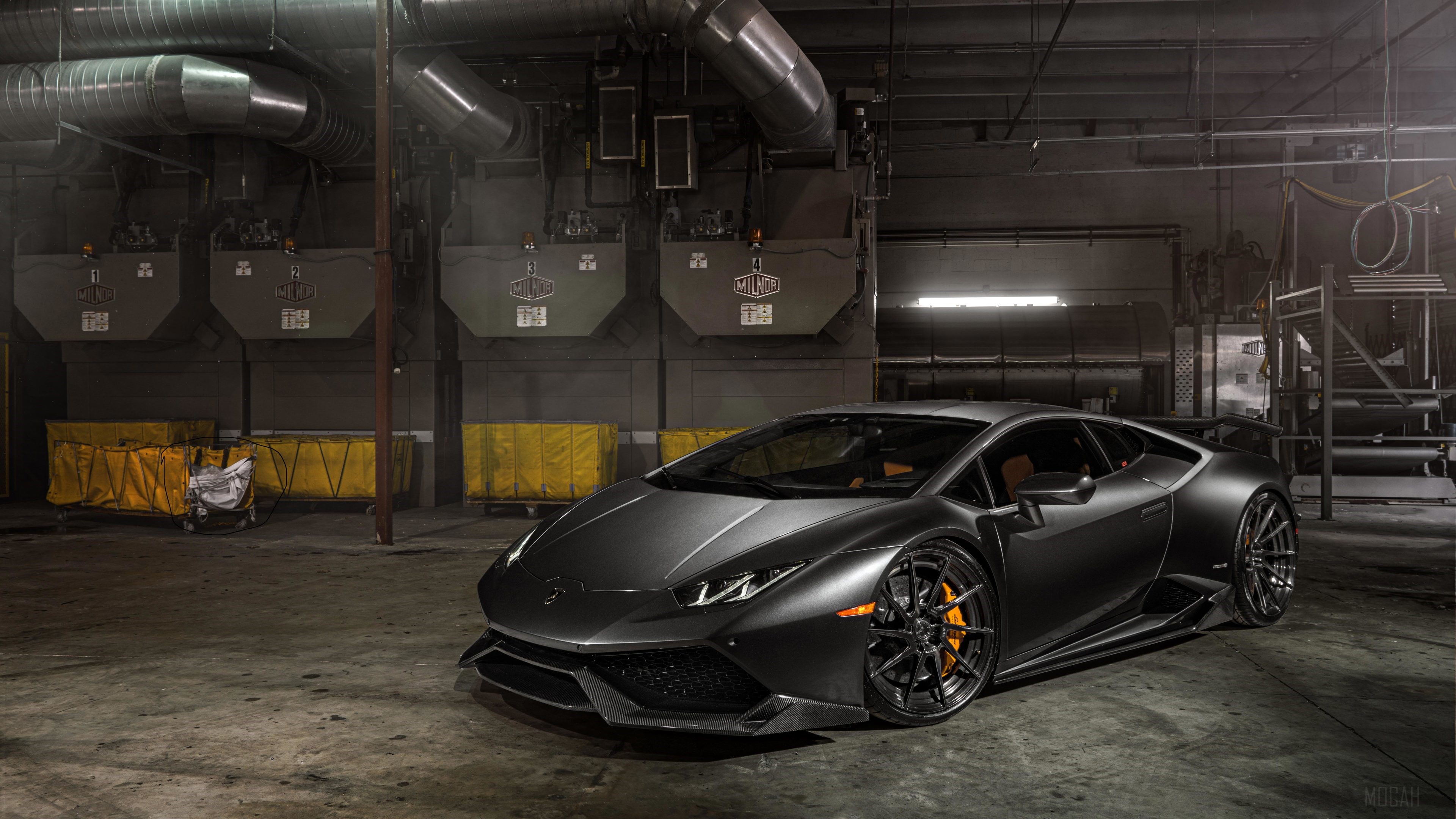 Matte black Lamborghini Huracan in a warehouse HD Wallpaper