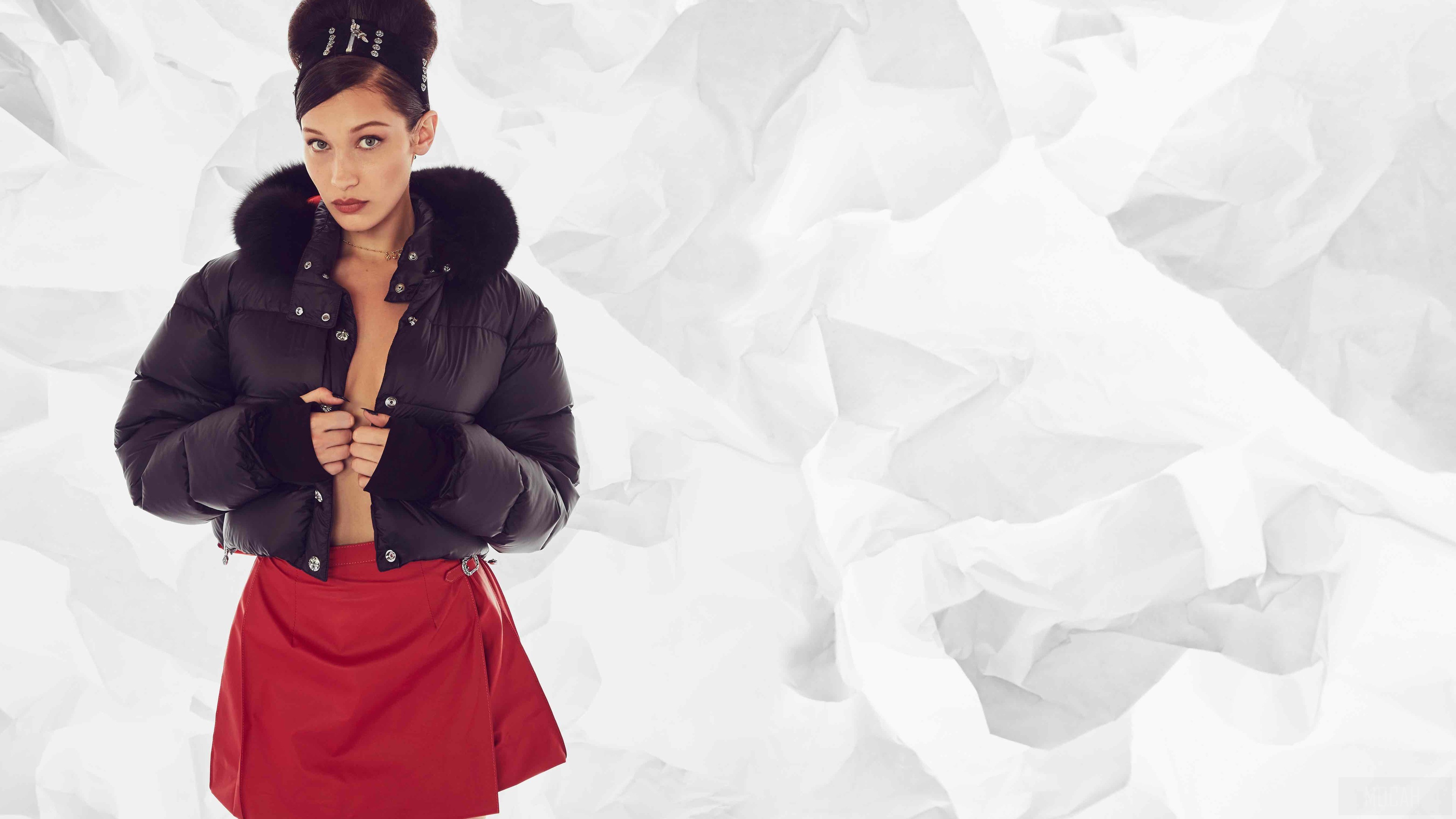 Bella Hadid in a black puffer jacket and red skirt HD Wallpaper