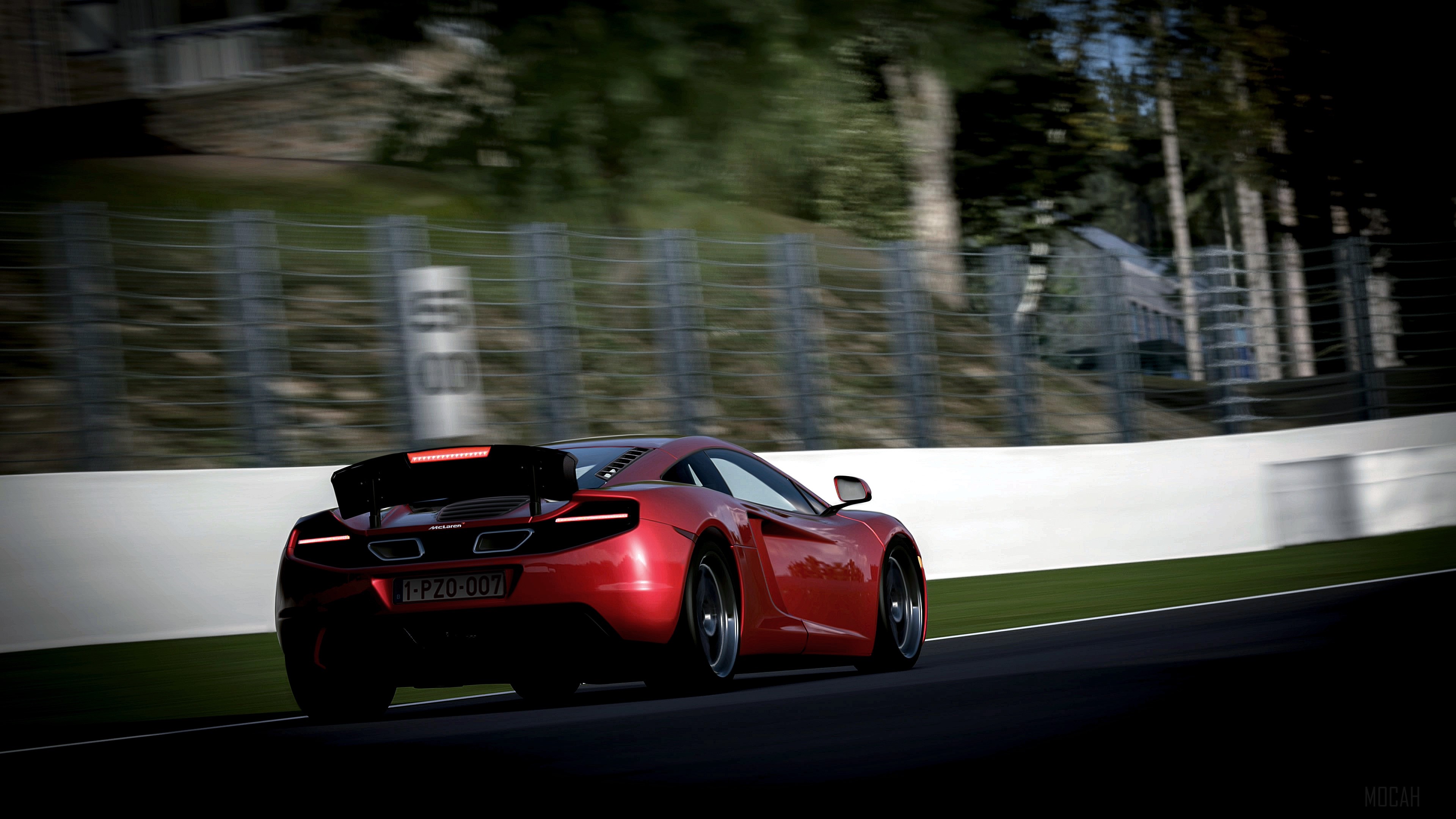Red McLaren car on a race track with motion blur HD Wallpaper