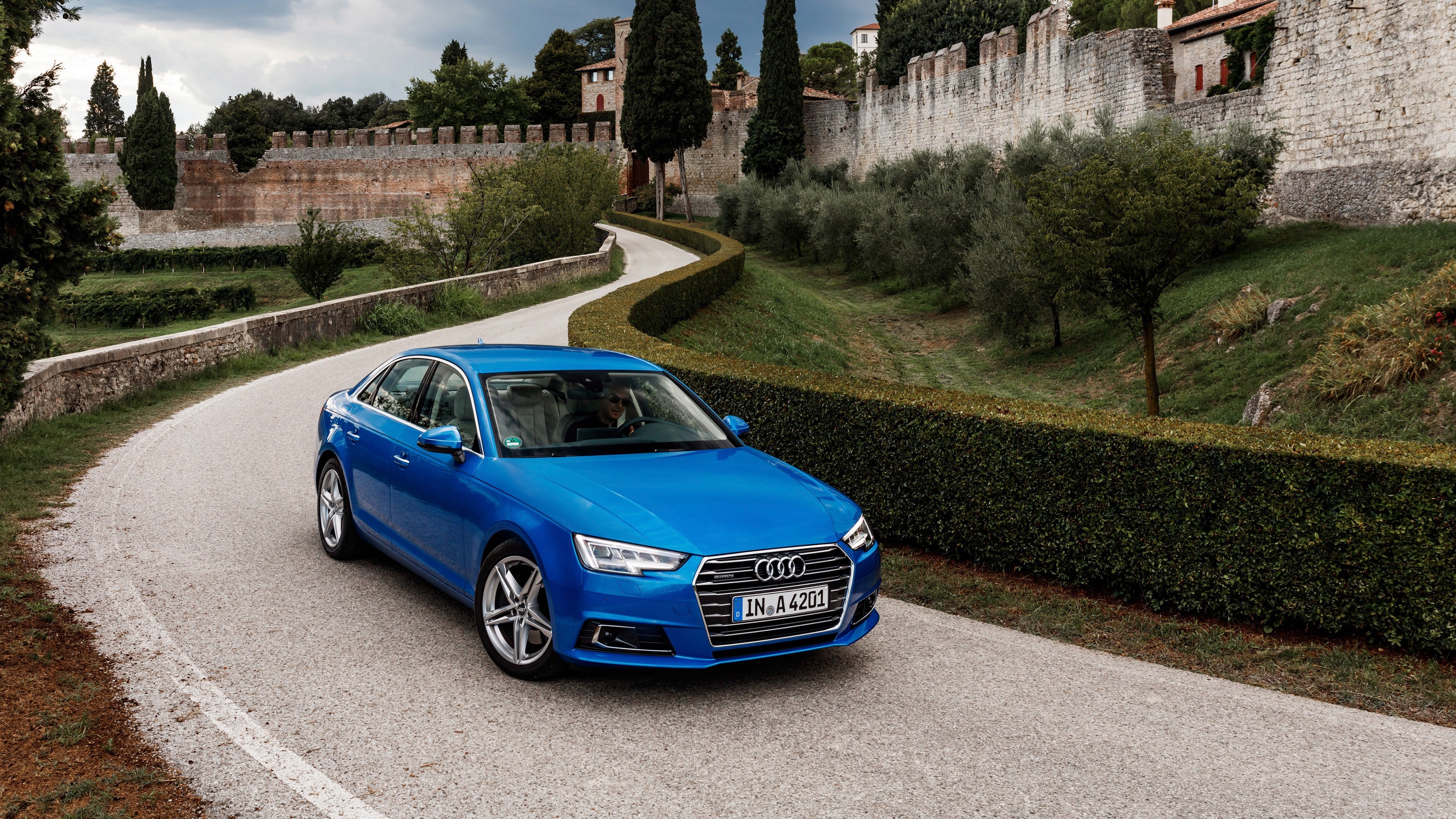 Blue Audi A4 TFSI Quattro driving on a road HD Wallpaper