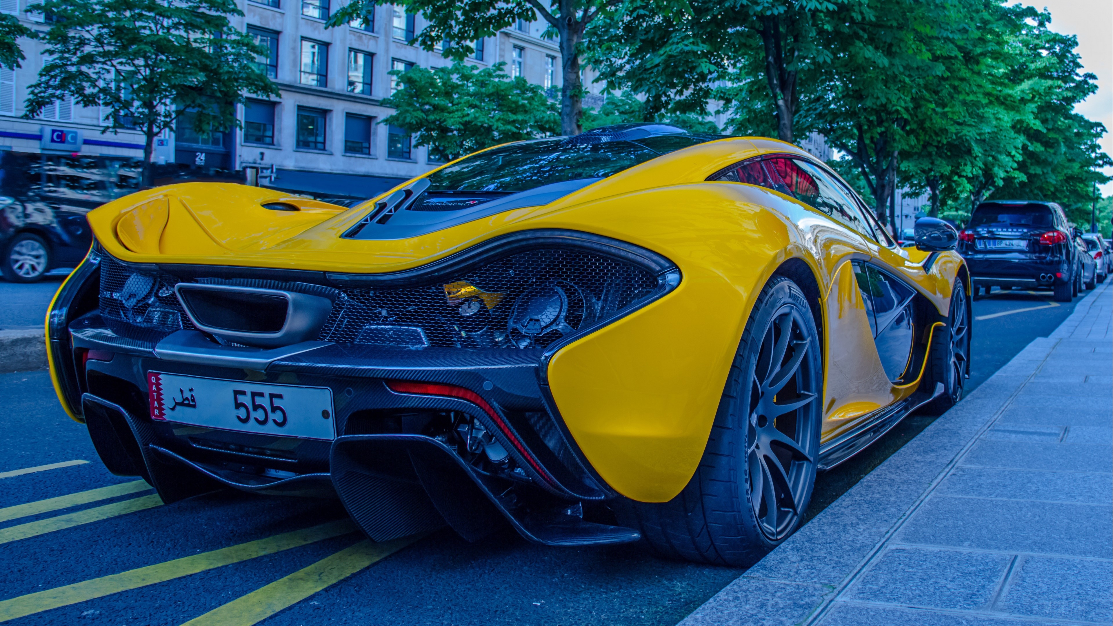 Yellow McLaren P1 sport car parked on street HD Wallpaper