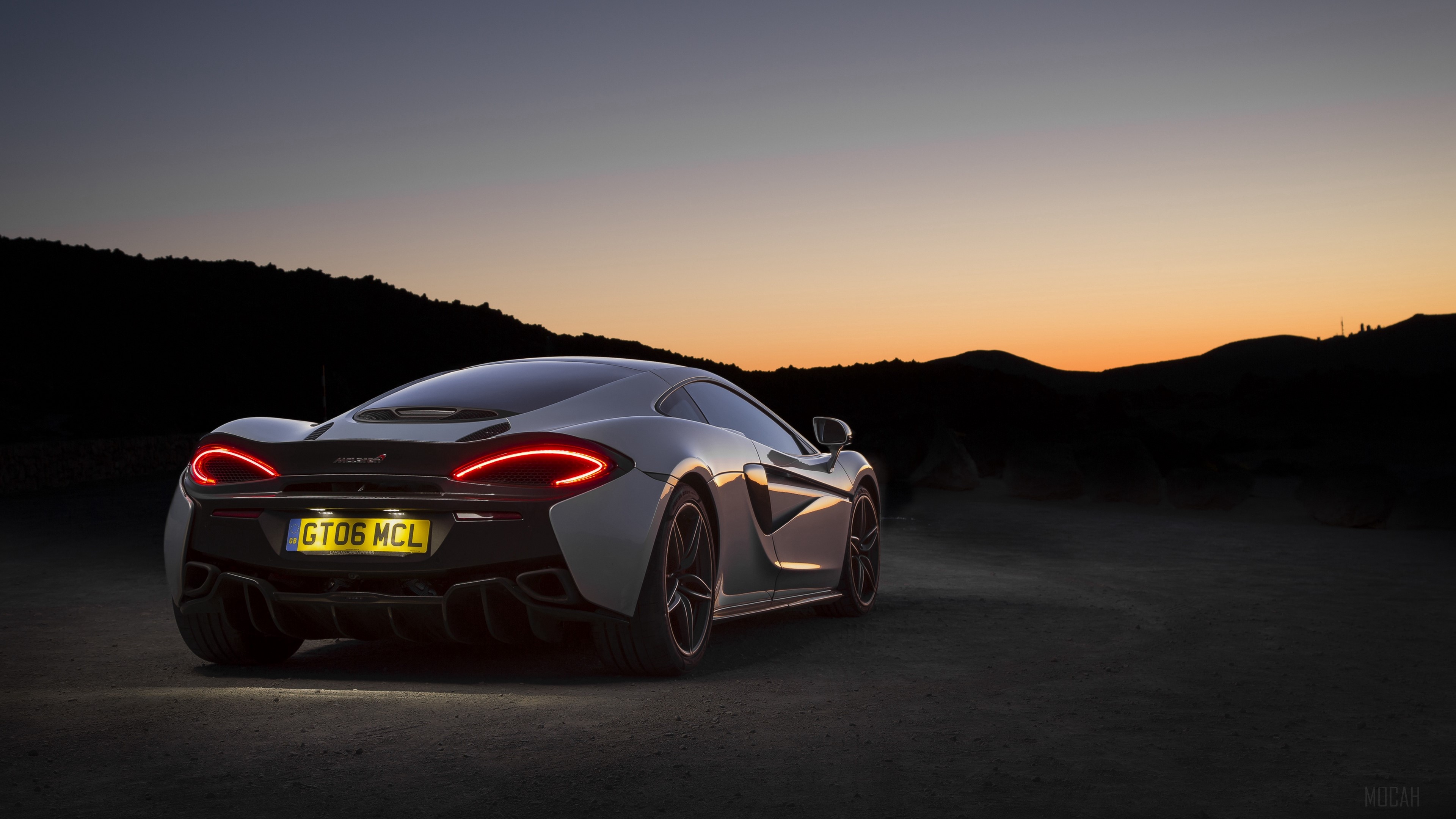 McLaren 570GT sports car at dusk HD Wallpaper